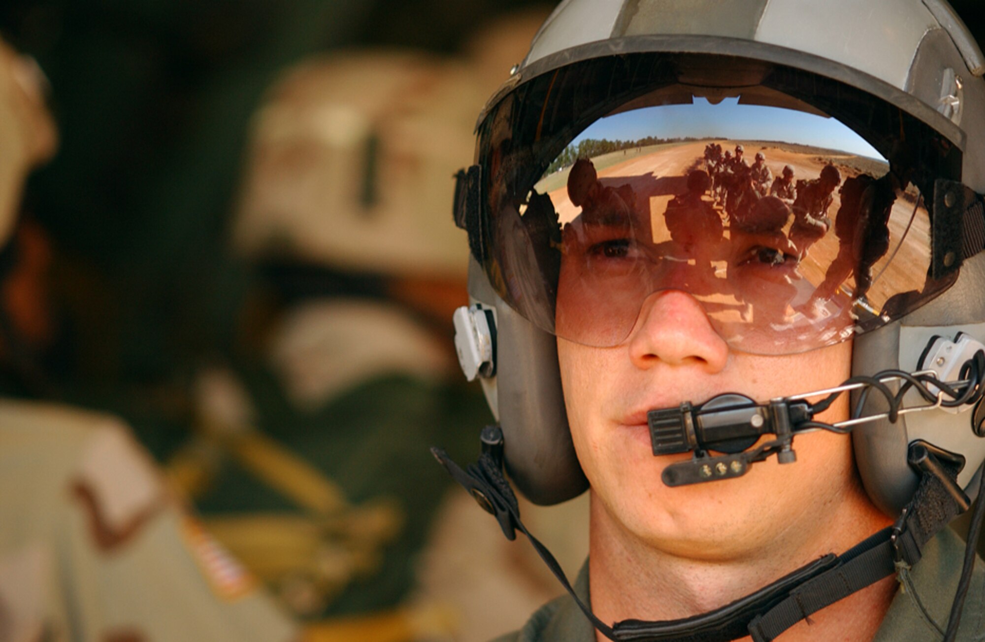 Reflecting on his most recent passengers, Senior Airman David Sanders, a C-130 Hercules aircrew loadmaster, closes a troop door after dropping off troops from the 82nd Airborne Division, Fort Bragg, N.C. (Photo by Staff Sgt. Matthew Hannen)