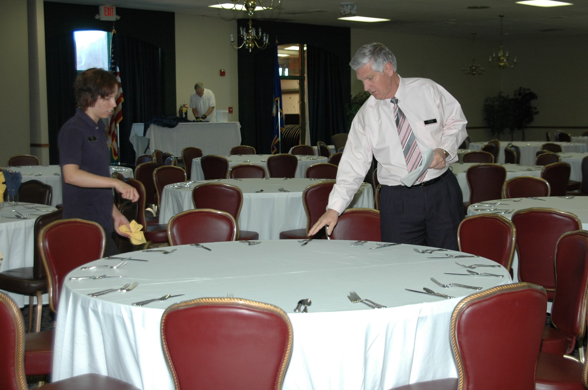 Garry Shaffer, Dakota's manager, helps Ms. Amber Green, Dakota's waitress, set tables prior to a banquet the club hosted.
Mr. Shaffer is the club's new manager and looks forward to revamping the club.