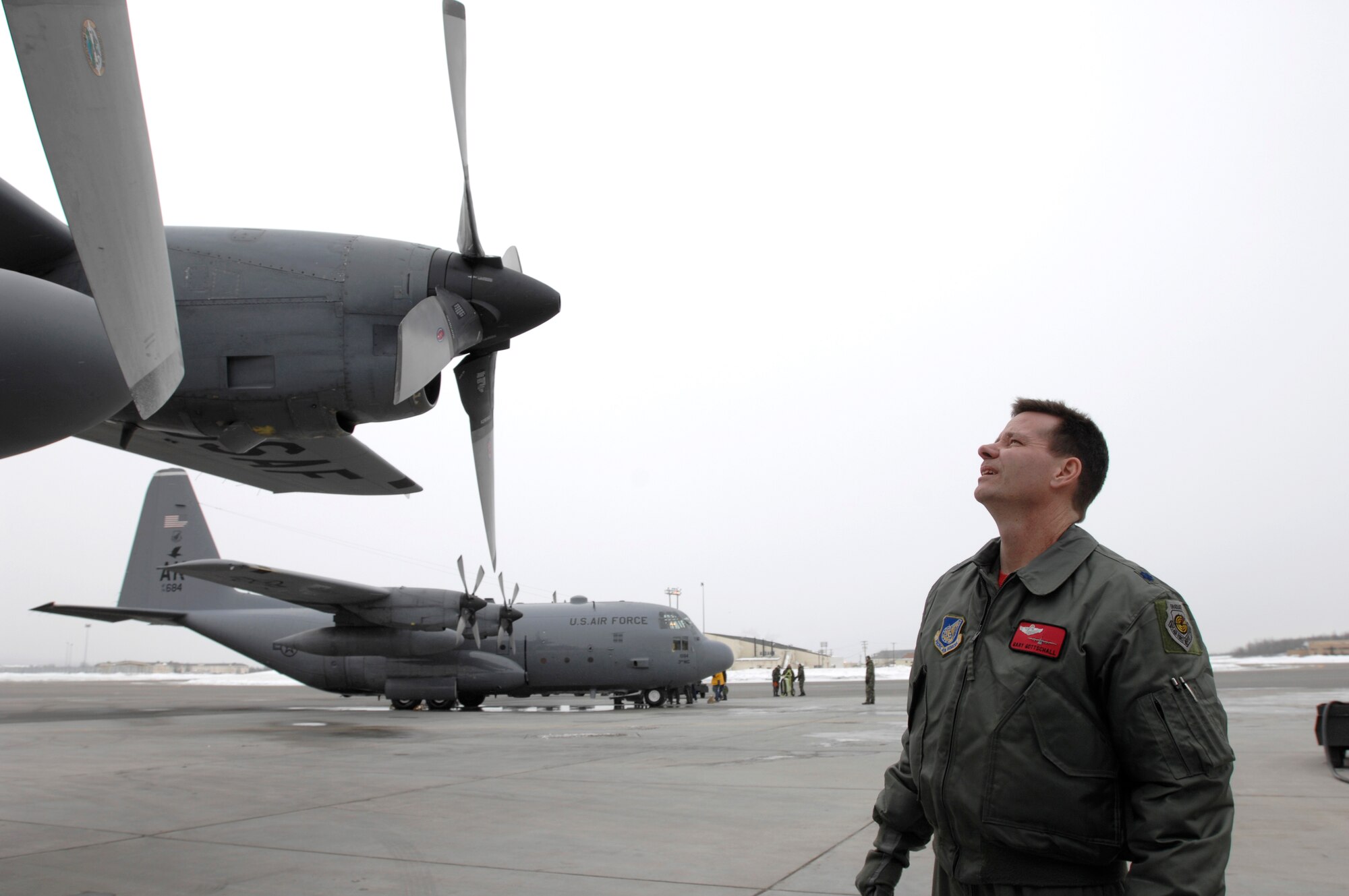 Lt. Col. Gary Gottschall performs a preflight inspection of his C-130 Hercules at Elmendorf Air Force Base, Alaska, March 23 prior to its final flight.  After 43 years of continuous service in Alaska, the flight will mark the end of the C-130 era at Elmendorf.  Airmen there soon will see C-17 Globemaster IIIs taking over the airlift mission.  Colonel Gottschall is the 517th Airlift Squadron commander.  (U.S. Air Force photo/ Tech Sgt Keith Brown)