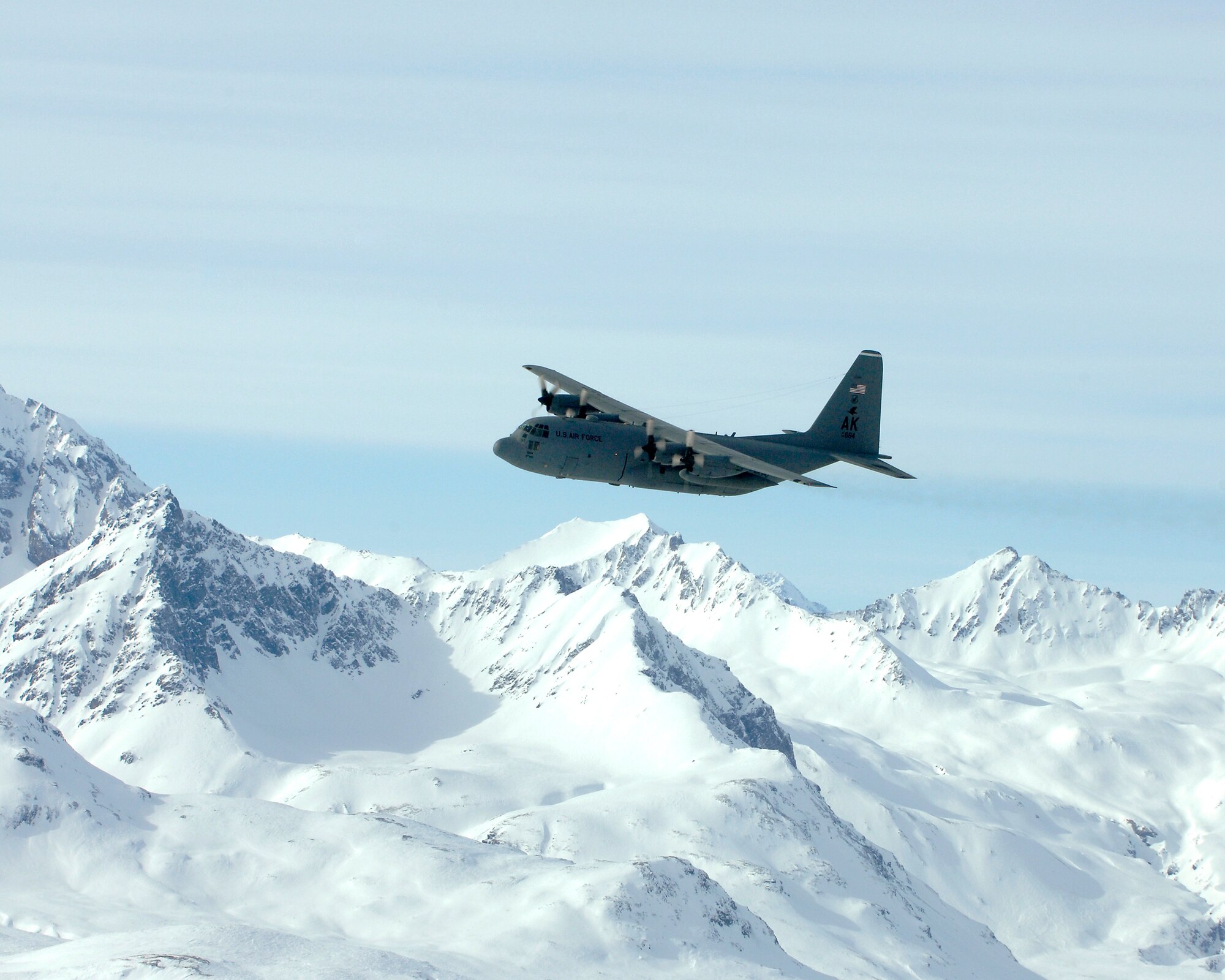 A C-130 Hercules from the 517th Airlift Squadron at Elmendorf Air Force Base, Alaska, flies over the Alaska Range during its final flight March 23.  After 43 years of continuous service in Alaska, the flight marked the end of the C-130 era at the 517th.  Airmen at Elmendorf soon will see C-17 Globemaster IIIs taking over the airlift mission. (U.S. Air Force photo/Tech Sgt Keith Brown)
