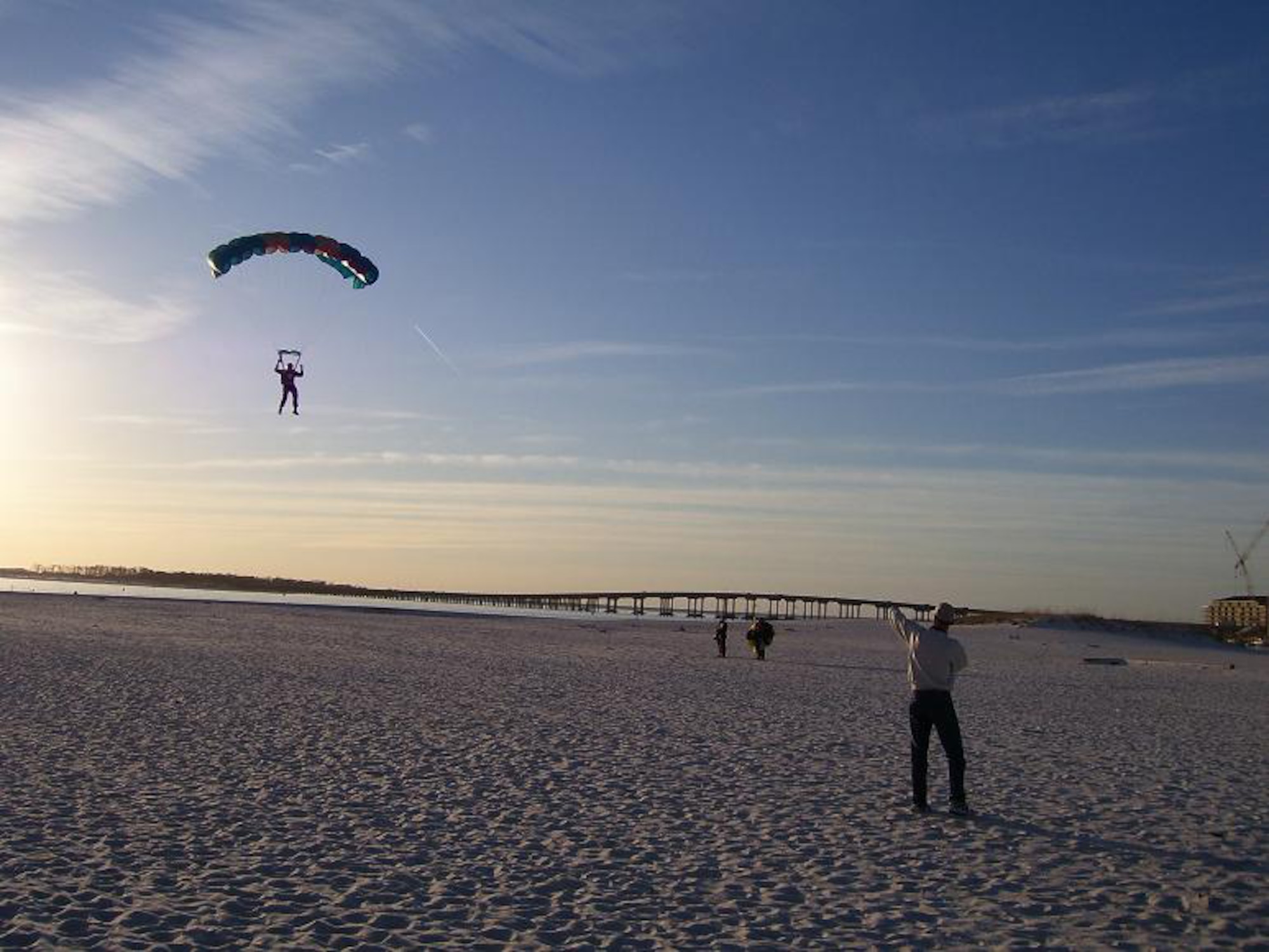 DESTIN, Fla. -- A skydiver prepares to touch down on the Emerald Coast landing zone of Noriega Point at Destin Harbor after leaping from the bomb bay of a B-17 Flying Fortress named "Nine-O-Nine." The World War II aircraft is named by the Collings Foundation in honor of a 91st Bomb Group, 323rd Squadron plane of the same name which completed 140 missions without an abort or loss of a crewman. (U.S. Air Force photo by 1st Lt. Dan Montes)