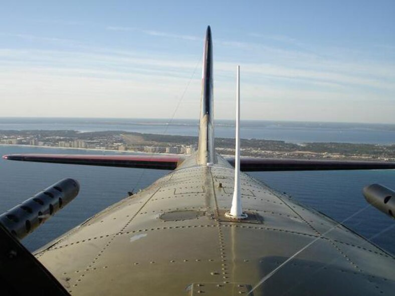 OVER GULF OF MEXICO, Fla. -- The Emerald Coast town of Destin, Fla., can be seen from the turret gunner's position on a B-17 Flying Fortress named "Nine-O-Nine." First Lt. Dan Montes, Air Force Research Laboratory, jumped out of the bomb bay March 3 to experience "living history" during a recent skydive. The aircraft is named by the Collings Foundation in honor of a 91st Bomb Group, 323rd Squadron plane of the same name which completed 140 missions without an abort or loss of a crewman. (U.S. Air Force photo by 1st Lt. Dan Montes) 