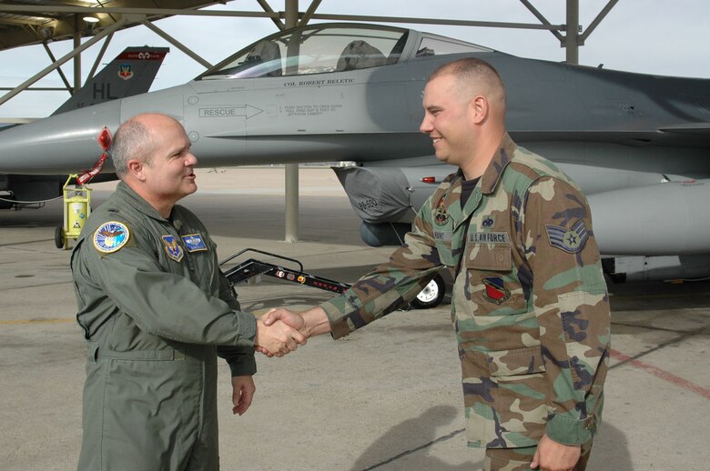 Brig. Gen. Charlie Lyon greets Staff Sgt. Bryan Hunt at the ribbon cutting ceremony for the aircraft shelters. The shelters will save 3,000 man hours and $130,000 in de-icing costs. Sergeant Hunt is a 388th FW crew chief. (U.S. Air Force photo by Airman 1st Class Stefanie Torres)
