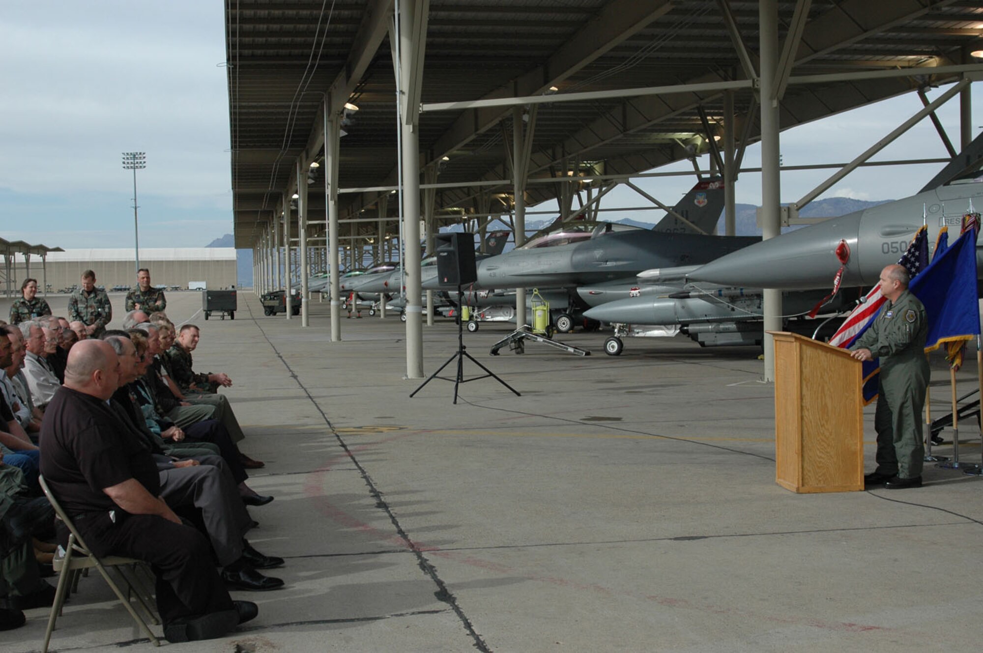 Brig. Gen. Charlie Lyon, the Deputy Director of Programs, Office of the Deputy Chief of Staff for Strategic Plans and Programs at the Pentagon and former 388th Fighter Wing commander, speaks to designated community visitors, Hill AFB leaders and 388th members about the aircraft shelter ribbon cutting ceremony March 26. General Lyon initially set away funds to build the aircraft shelters during his tenure at the wing. (U.S. Air Force photo by Airman 1st Class Stefanie Torres)