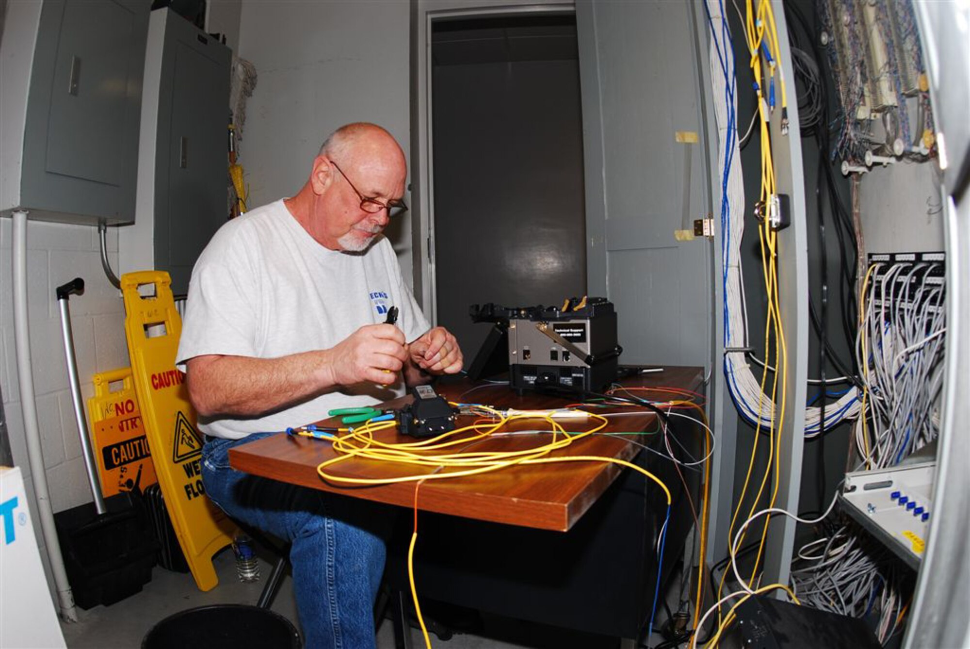 GRISSOM AIR RESERVE BASE, Ind., --  Phil Cruea, 434th Communications Squadron air traffic control and landing landing systems technician, splices fiber optic cable for the local area network. Mr. Cruea is the only person at Grissom trained in fiber optic cable installation on the base. (U.S. Air Force photo/Master Sgt. Steve Robertson)