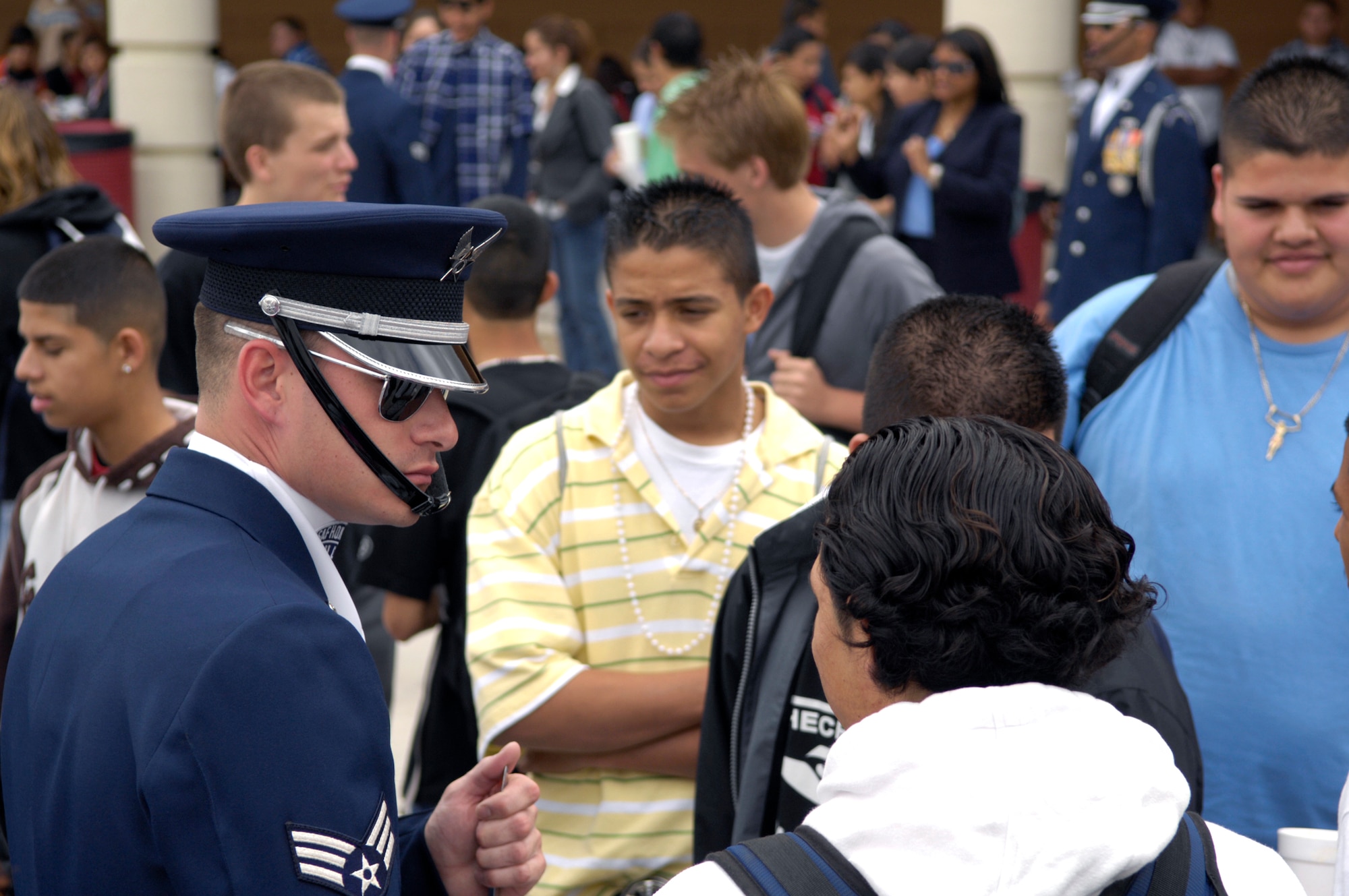 Senior Airman Adam Clonick, of the United States Air Force Honor Guard Drill Team, speaks with students March 23 after the team's performance at Dysart High School in El Mirage, Ariz. The drill team is the traveling component of the Air Force Honor Guard and tours Air Force bases worldwide showcasing the precision of today's Air Force to recruit, retain and inspire Airmen for the Air Force mission. (U.S. Air Force photo/Airman 1st Class Rusti Caraker) 