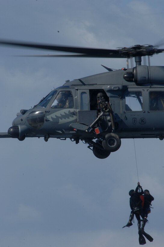 Pararescuemen from the 38th Rescue Squadron are hoisted by an HH-60G Pave Hawk from the 41st RQS, during a dive recovery exercise March 22 in the Gulf of Mexico. The 38th and 41st RQS from Moody Air Force Base, Ga., are taking part in the base's operational readiness exercise, Commando Angel. (U.S. Air Force photo/Senior Airman Joshua T. Jasper) 