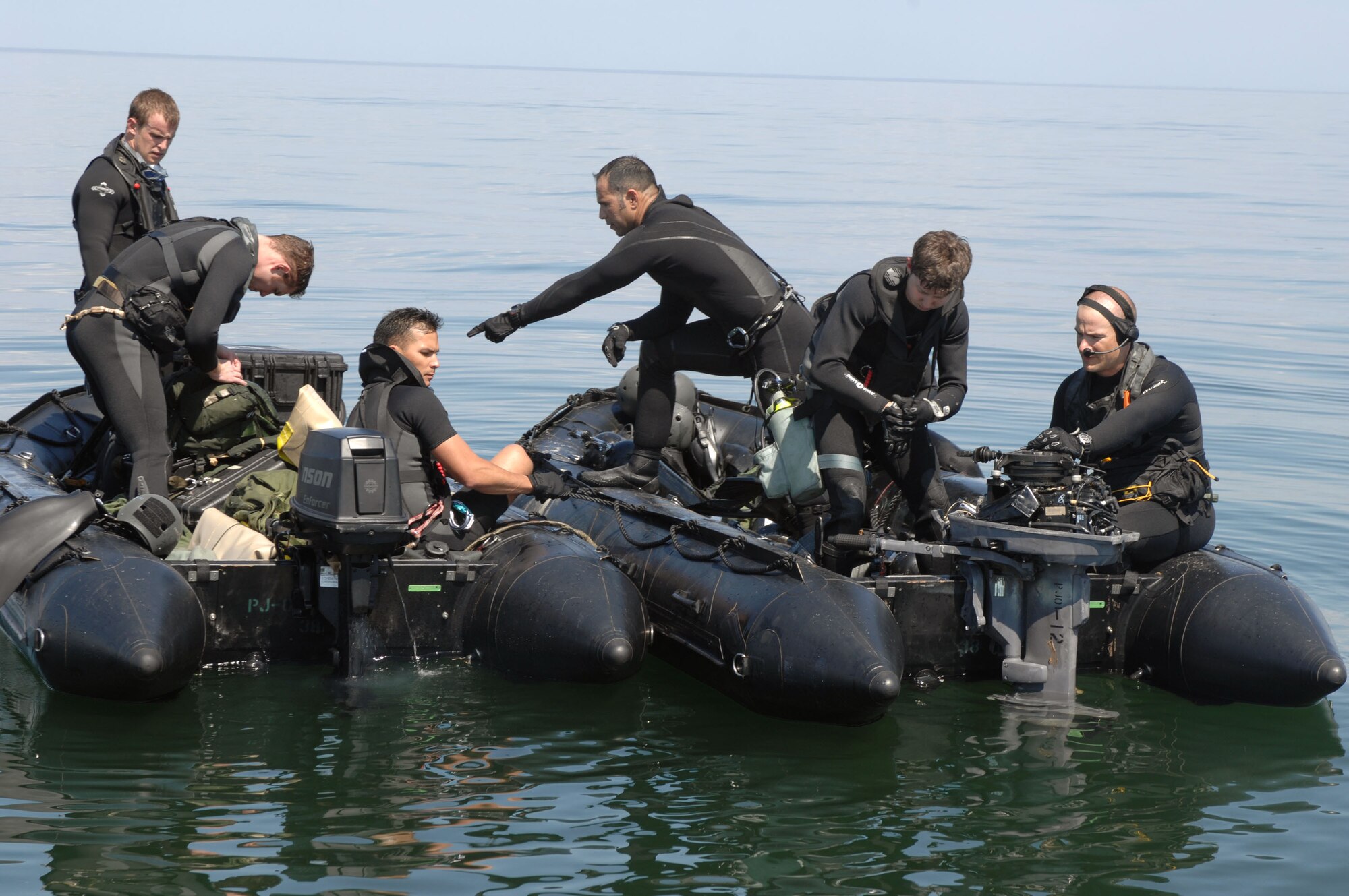 A pararescue team from the 38th Rescue Squadron of Moody Air Force Base, Ga., prepares their gear for a crash recovery dive scenario March 22 in the Gulf of Mexico after a parachute drop. The scenario was part of Moody AFB's operational readiness exercise, Commando Angel. (U.S. Air Force photo/Senior Airman Joshua T. Jasper) 
