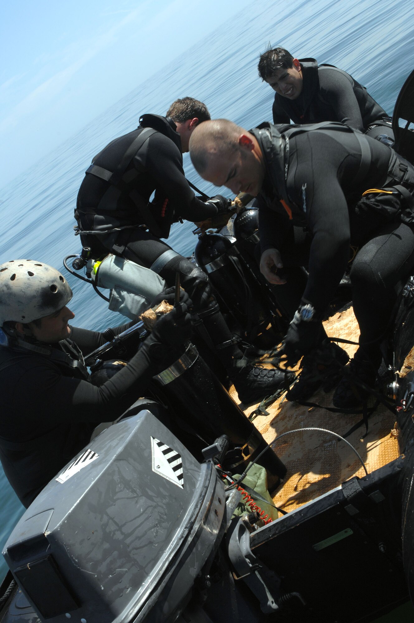 A pararesue team from the 38th Rescue Squadron of Moody Air Force Base, Ga., prepares their gear for a crash recovery dive scenario March 22 in the Gulf of Mexico. The scenario was part of the Moody AFB's operational readiness exercise, Commando Angel. (U.S. Air Force photo/Senior Airman Joshua T. Jasper)