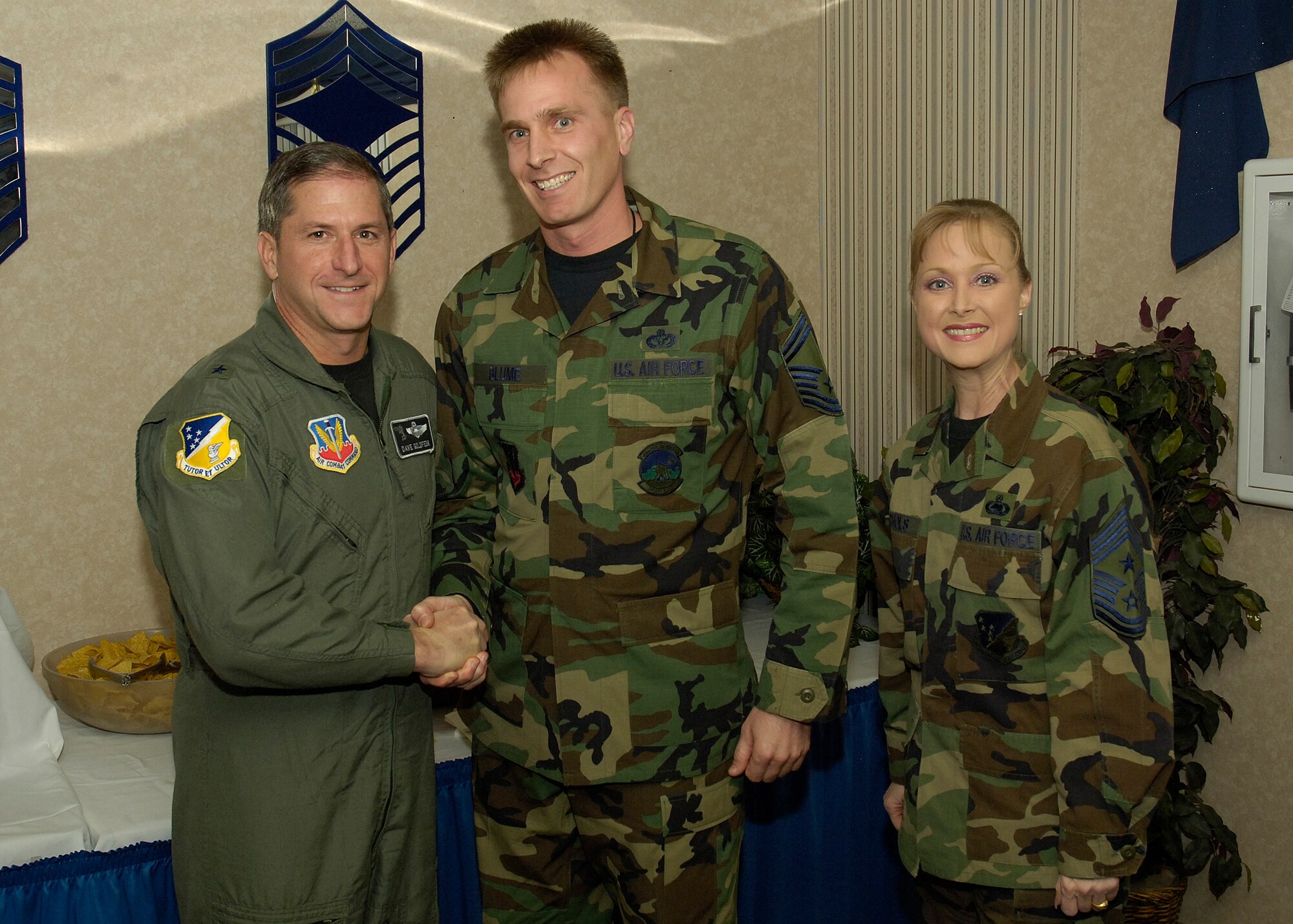 Senior Master Sgt. Larry Blume, 49th Civil Engineer Squadron superintendent, is congratulated by Brig. Gen. David Goldfein, 49th Fighter Wing commander and Chief Master Sgt. Marjorie McNichols, 49 FW command chief.