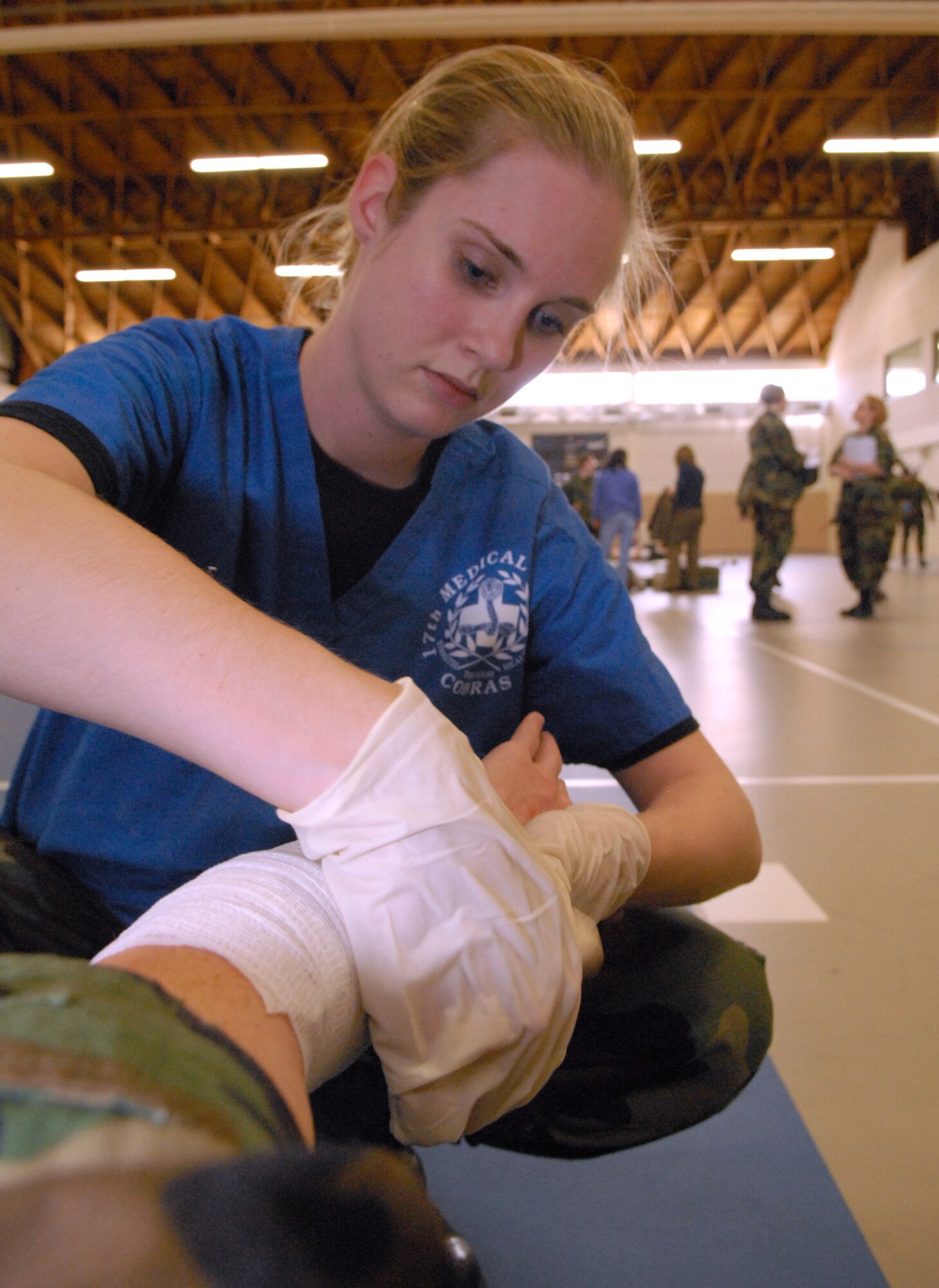 Staff Sgt. April Miller wraps the arm of a victim during the natural disaster exercise March 13 at Goodfellow Air Force Base. (U.S. Air Force photo by Tech. Sgt. Randy Mallard)