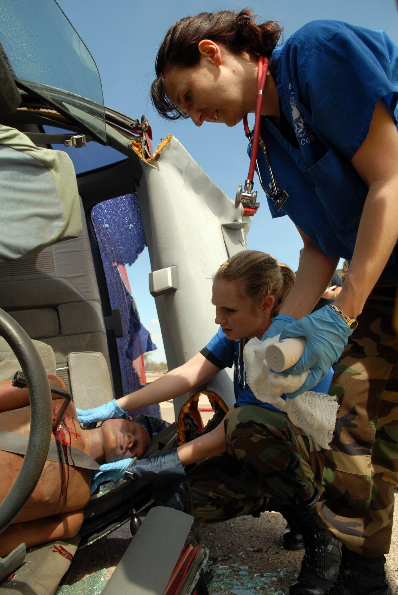 Members of the 17th Medical Group assess the extent of the injuries of a dummy posing as a car accident victim during Goodfellow Air Force Base’s first natural disaster exercise for 2007 on March 13. (U.S. Air Force photo by Tech. Sgt. Randy Mallard)