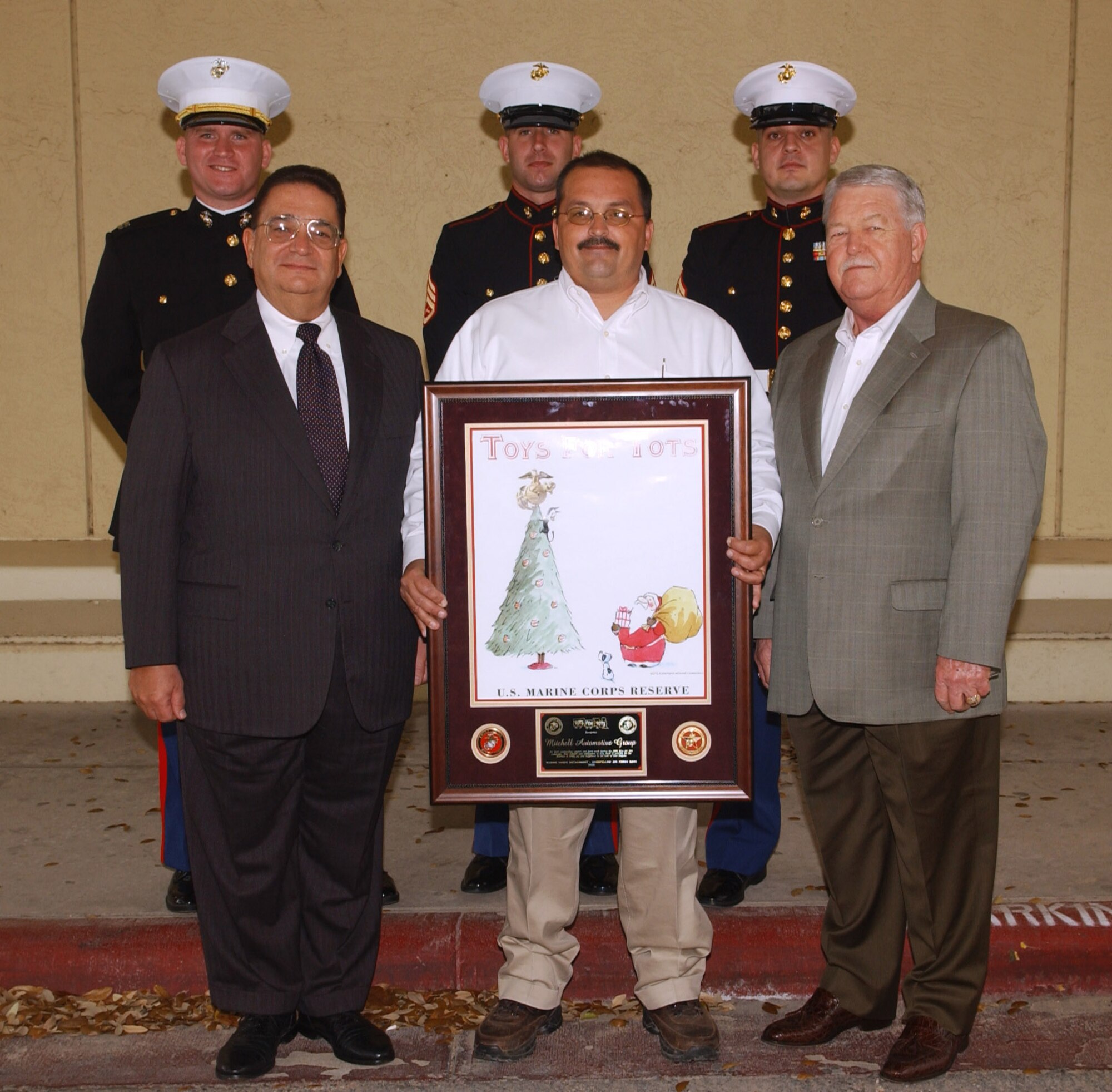 (Back row, from left to right): Marine Capt. Henry Billings, Marine Staff Sgt. John Juras and Gunnery Sgt. Jacob Eckes, all of the Marine Corps Detachment at Goodfellow, pose for a photo behind Honorary Chief Master Sgt. Mike Mitchell, Tony Palmer (recipient) and Terry Reynolds after a special presentation by the San Angelo City Council to Mr. Palmer in recognition of his eight years of service as the off-base coordinator for the Toys for Tots campaign, Tuesday during a city council meeting at the San Angelo Convention Center.

“Mr. Palmer’s unselfish dedication to the drive provides a service that is invaluable to Toys for Tots,” said Master Gunnery Sgt. Chauncey Lovely, also of the Marine Corps Detachment. “Not only does he bring smiles to the faces of kids, he brings a great deal of pleasure to the Marine Corps Detachment and our staff. He is surely a great humanitarian,” Sgt. Lovely continued. (U.S. Air Force photo by Airman 1st Class Kamaile Chan).
