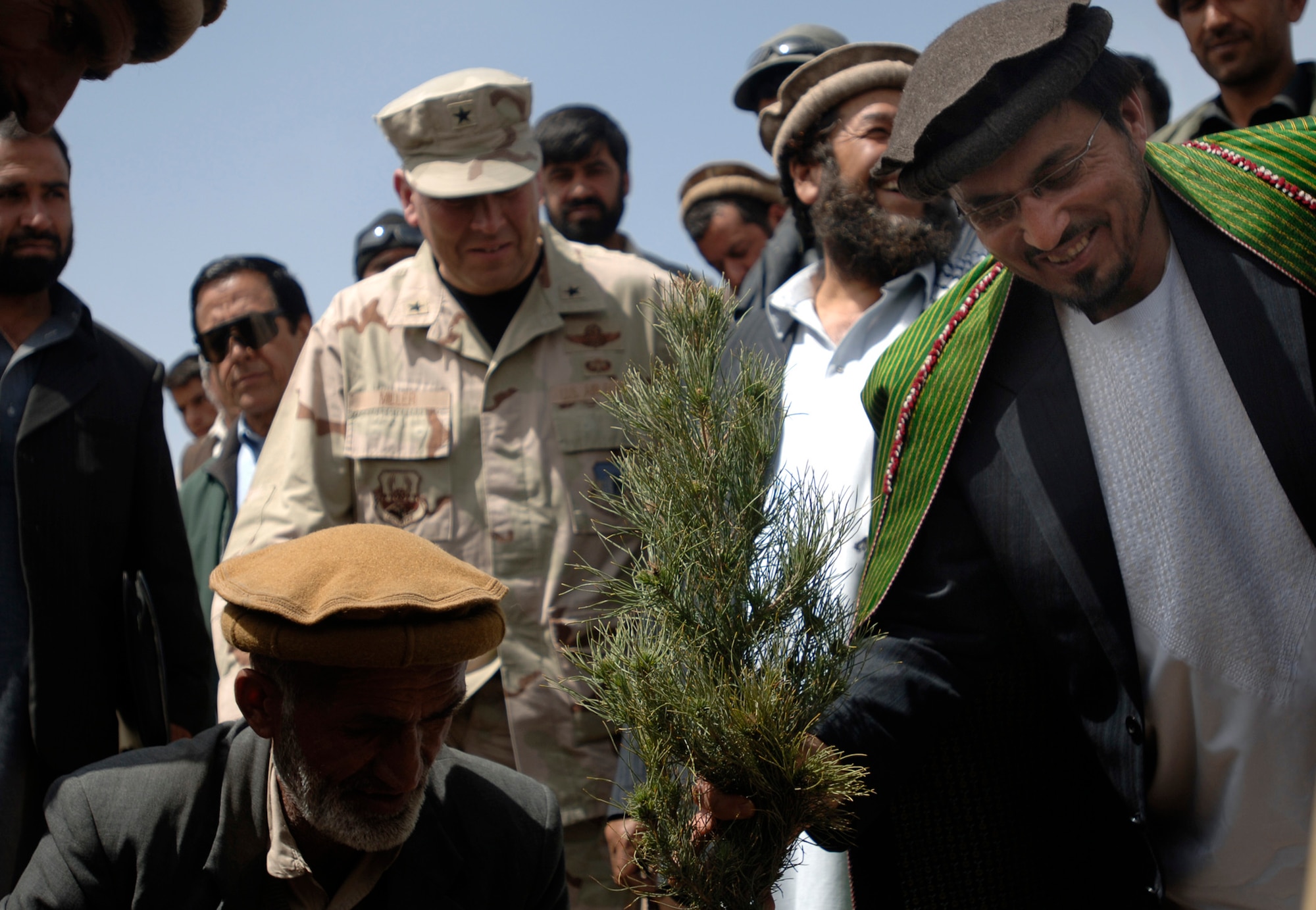Hamidullah Hatam, accompanied by Brig. Gen. Christopher Miller, plants one of 3,000 pine and fruit tree saplings donated by the U.S. Bagram Provincial Reconstruction Team at Mahmud Raqi High School in Deh Baba Ali, Afghanistan, March 26. Bagram PRT members aided in building the high school and also donated several bundles of school supplies.  Mr. Hatam is the education administer advisor for the Afghan Ministry of Education.  General Miller is the 455th Expeditionary Wing commander.  (U.S. Air Force photo/Tech. Sgt. Cecilio M. Ricardo Jr.)