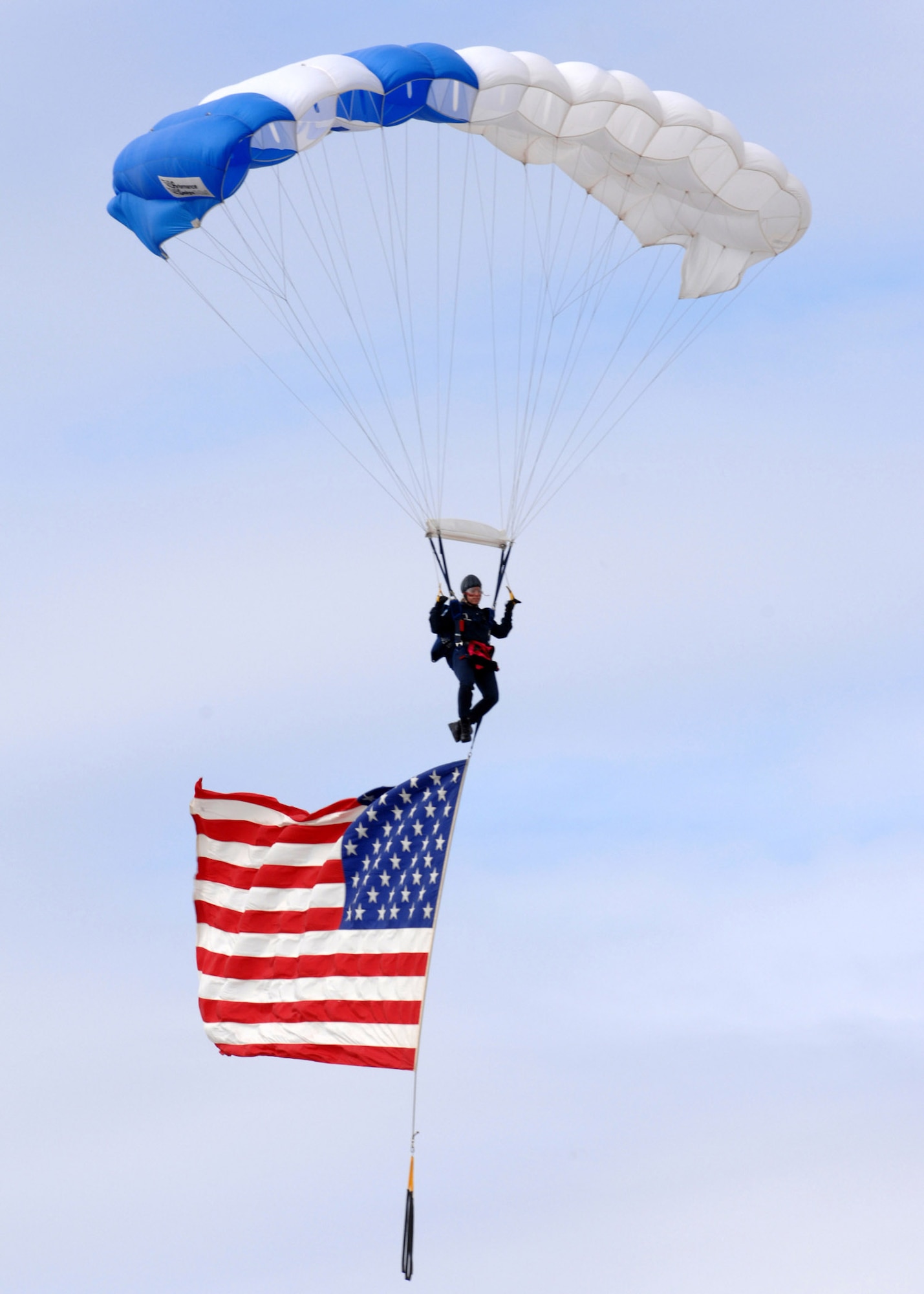 Cadet 1st Class Ilea Eskildsen, U.S. Air Force Academy's Wings of Blue Parachute Demonstration Team, parachutes down to Luke Air Force Base, Ariz., with the American Flag during the "The Show of Force 2007, From Heritage to Horizons Air Show" March 24. The two-day air show attracted thousands of spectators, featured Air Force static displays, and included civilian and military arial demonstrations.  The show was part of Air Force Week, a week-long event designed to highlight the amazing things the Air Force is doing around the globe and to show appreciation to the local community for its support. (U.S. Air Force photo/Staff Sgt. Brian Ferguson)