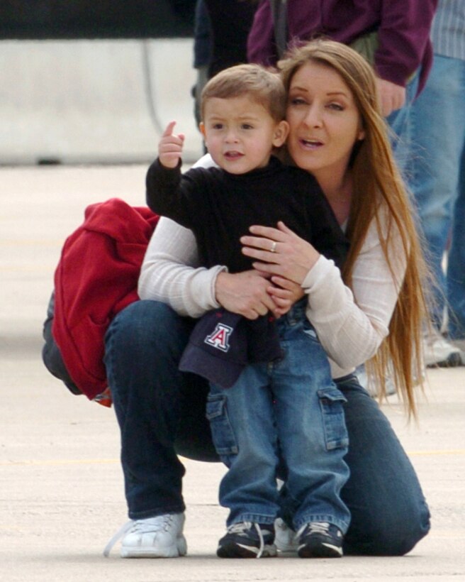 Julie and Elijah Zamora look watch an arial demonstration at "The Show of Force 2007, From Heritage to Horizons Air Show" at Luke Air Force Base, Ariz., March 24.  The show was part of Air Force Week, a week-long event designed to highlight the amazing things the Air Force is doing around the globe and to show appreciation to the local community for its support.  (U.S. Air Force photo/Staff Sgt. Brian Ferguson)