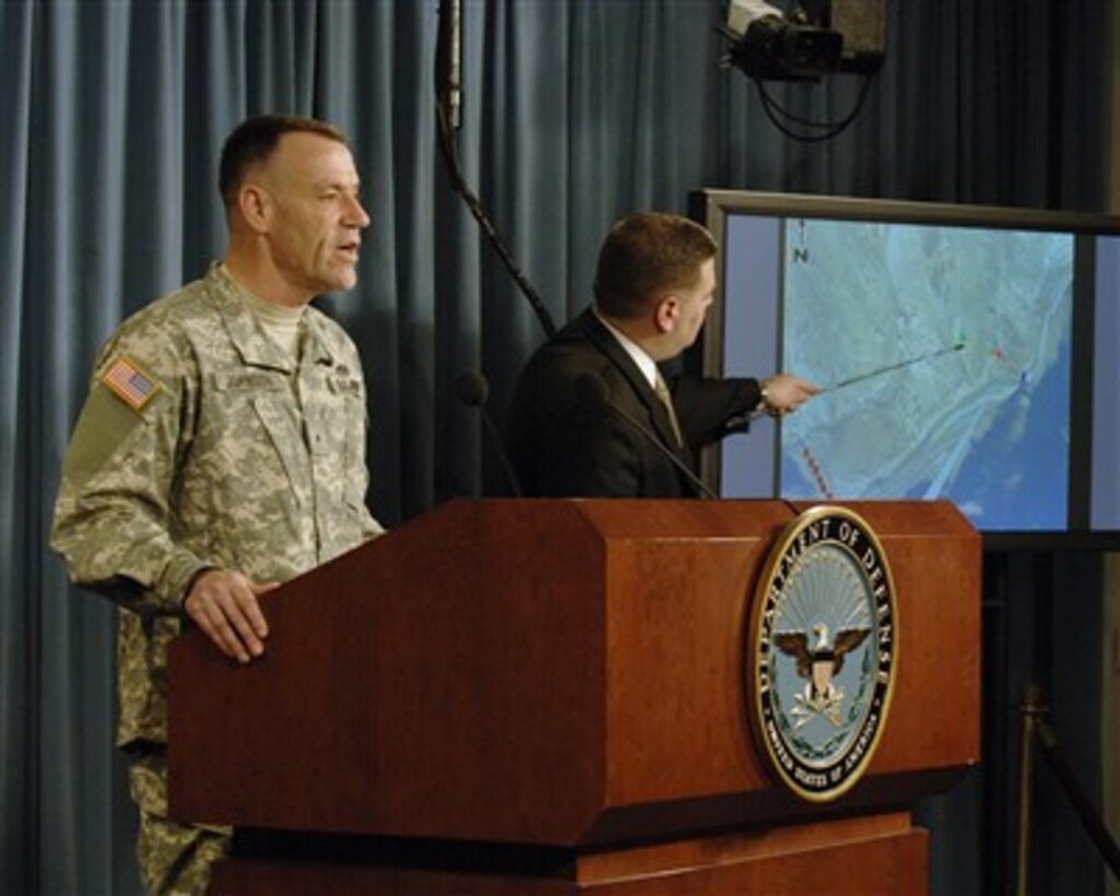 Brig. Gen. Rodney L. Johnson (left), U.S. Army Criminal Investigation Command, presents the findings of the investigation into the events and circumstances surrounding the 2004 death of Army Cpl. Patrick Tillman as an agent orients it on a map during a Pentagon press briefing on March 26, 2007.  
