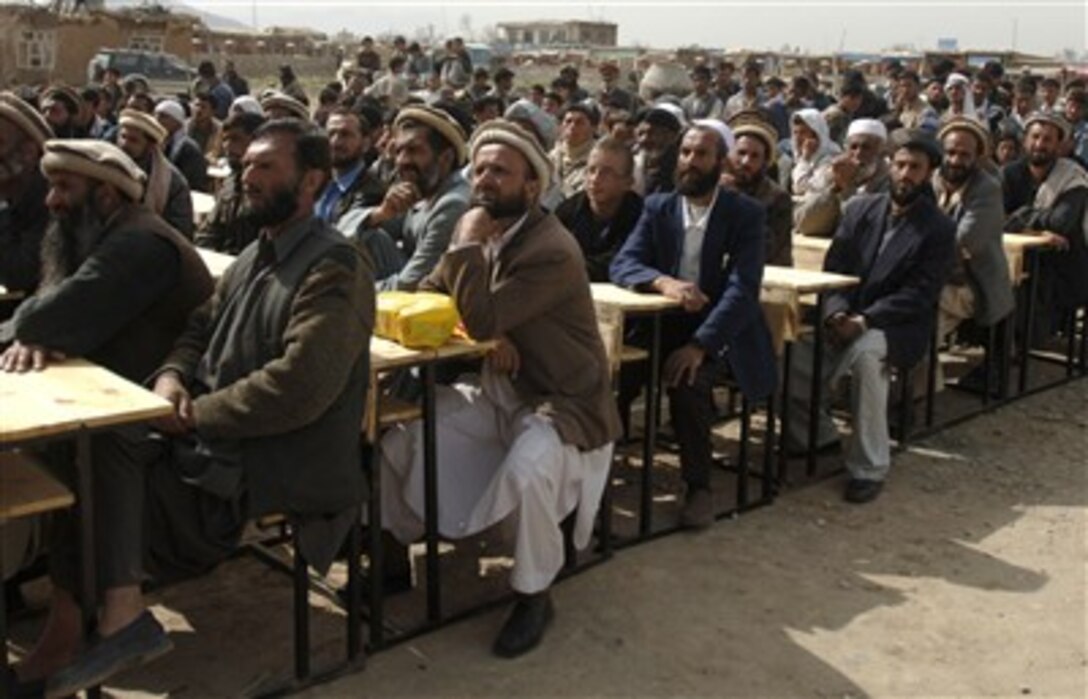 Hundreds of local Afghan men and women, along with Bagram Provincial Reconstruction Team members, attend a ceremony celebrating the Afghan New Year and the first day of school at the Mahmud Raqi High School in Deh Baba Ali, Afghanistan, March 26. 