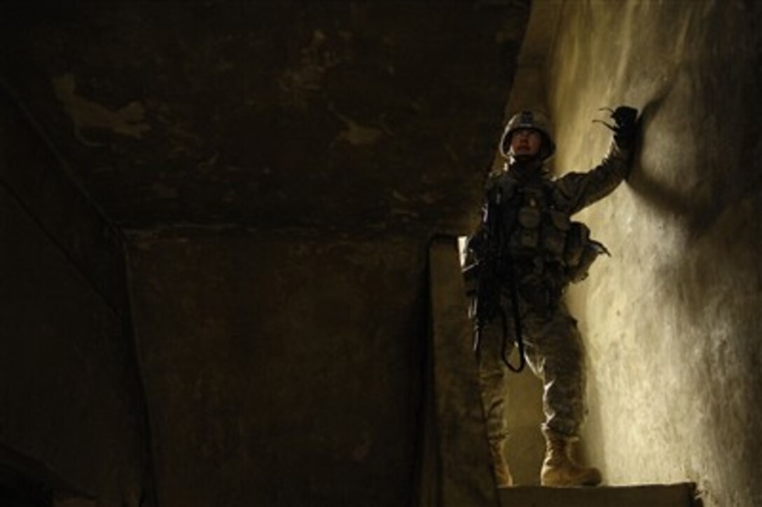 A U.S. Army soldier pauses in the stairwell during a search of a suspected insurgent's house in Shakarat, Iraq, on March 23, 2007.  The soldier is from the 6th Battalion, 9th Cavalry Regiment, 3rd Brigade Combat Team, 1st Cavalry Division and is in Shakarat conducting patrols and building an Army combat outpost.  