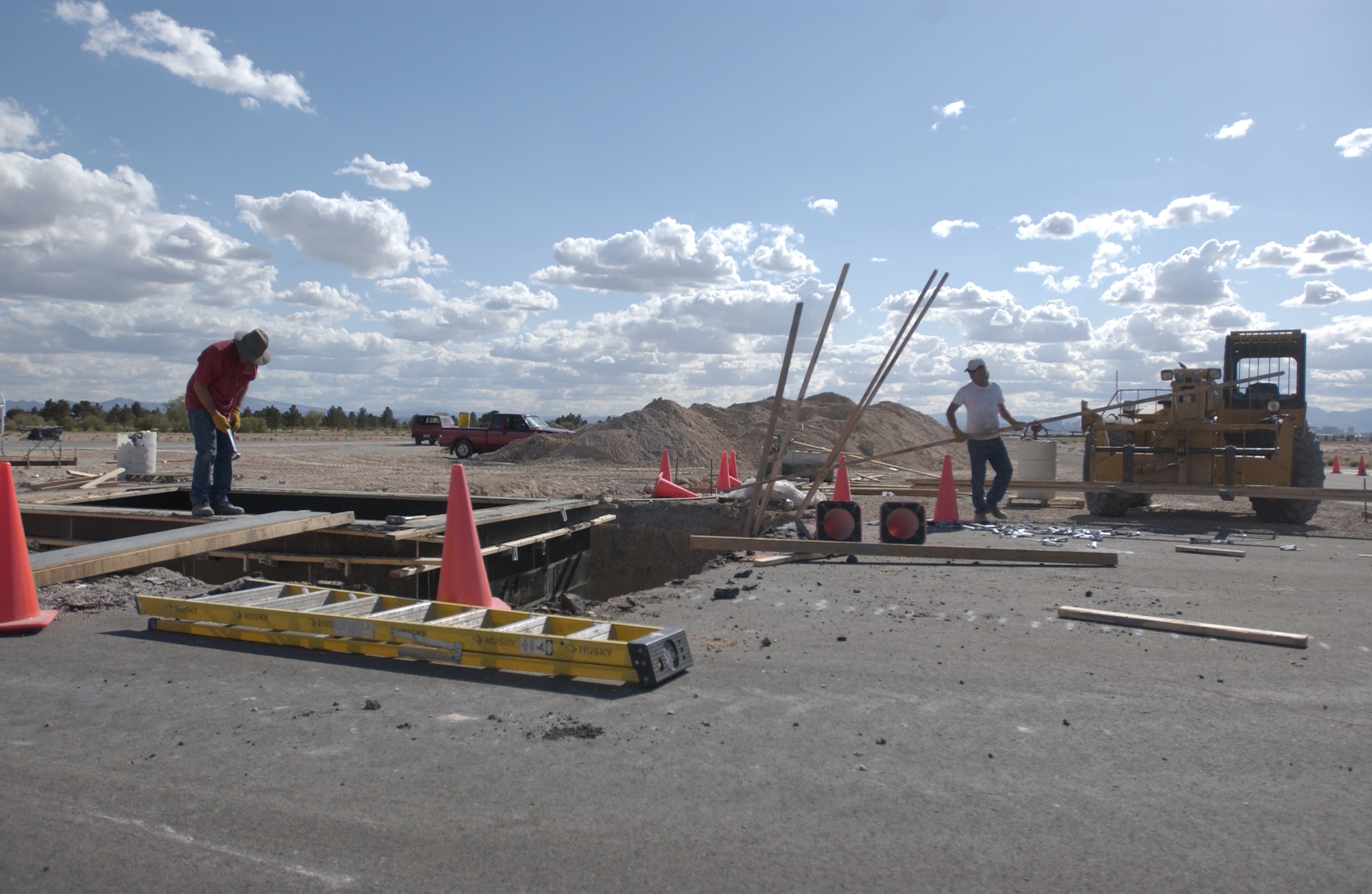 Construction crew members work on the ongoing flight line construction project, head by the 99th Civil Engineering Squadron to repair a section of the taxiway .
(U.S Air Force Photo/Senior Airman Larry E. Reid Jr.)     