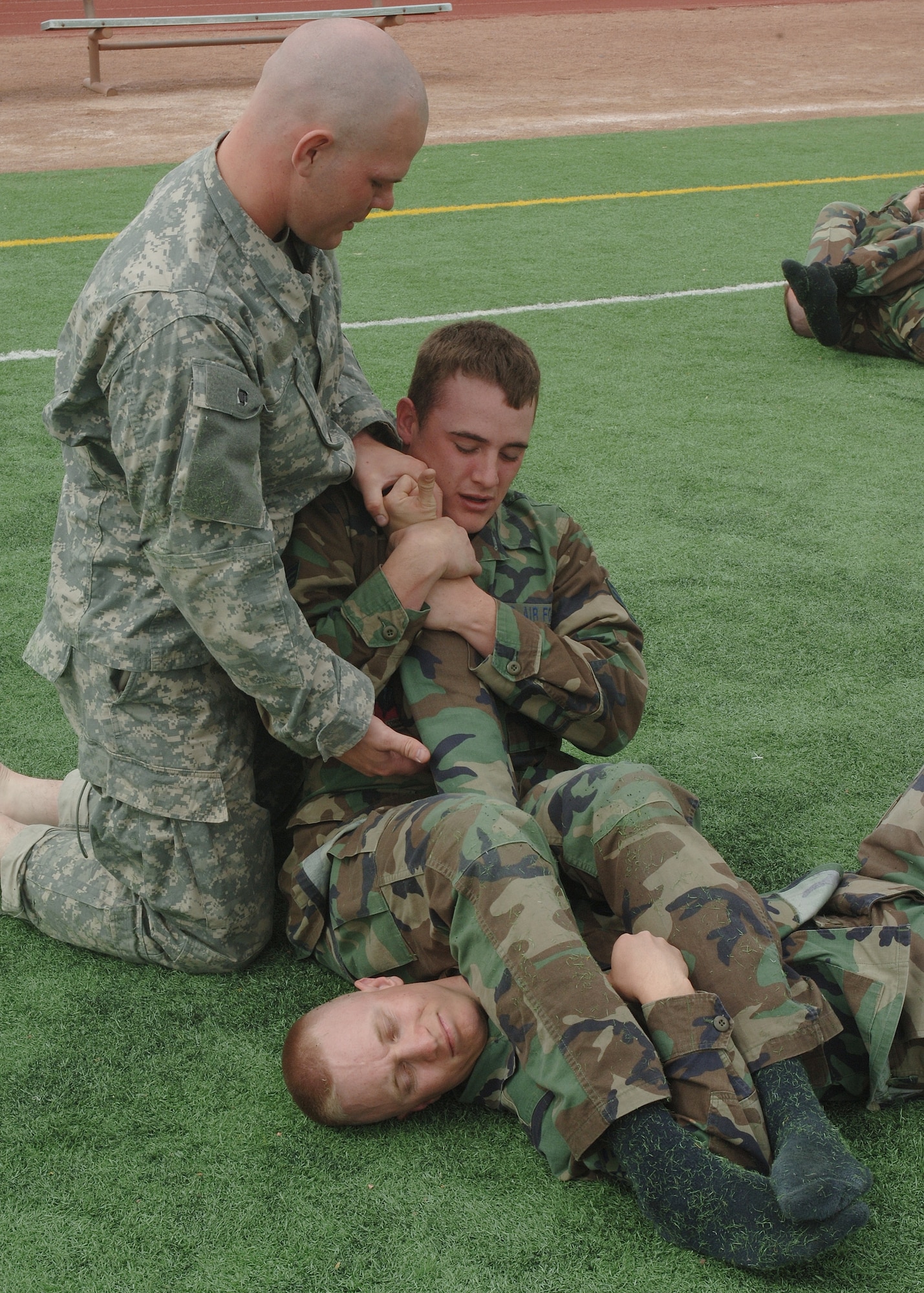 A Soldier from Fort Bliss, Texas, gives pointers to two Airmen during hand-to-hand combat training March 21 at Holloman. (U.S. Air Force photo by Airman 1st Class John Strong)