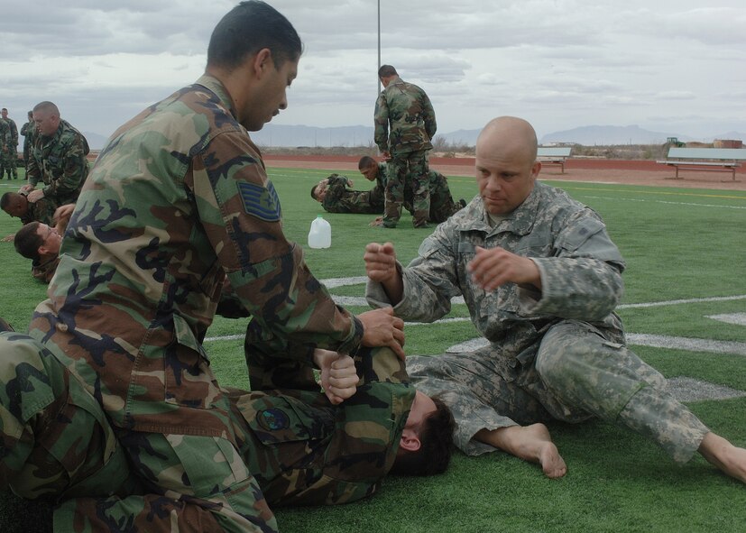 A Soldier from Fort Bliss, Texas, gives pointers to two Airmen during hand-to-hand combat training March 21 at Holloman. (U.S. Air Force photo by Airman 1st Class John Strong)