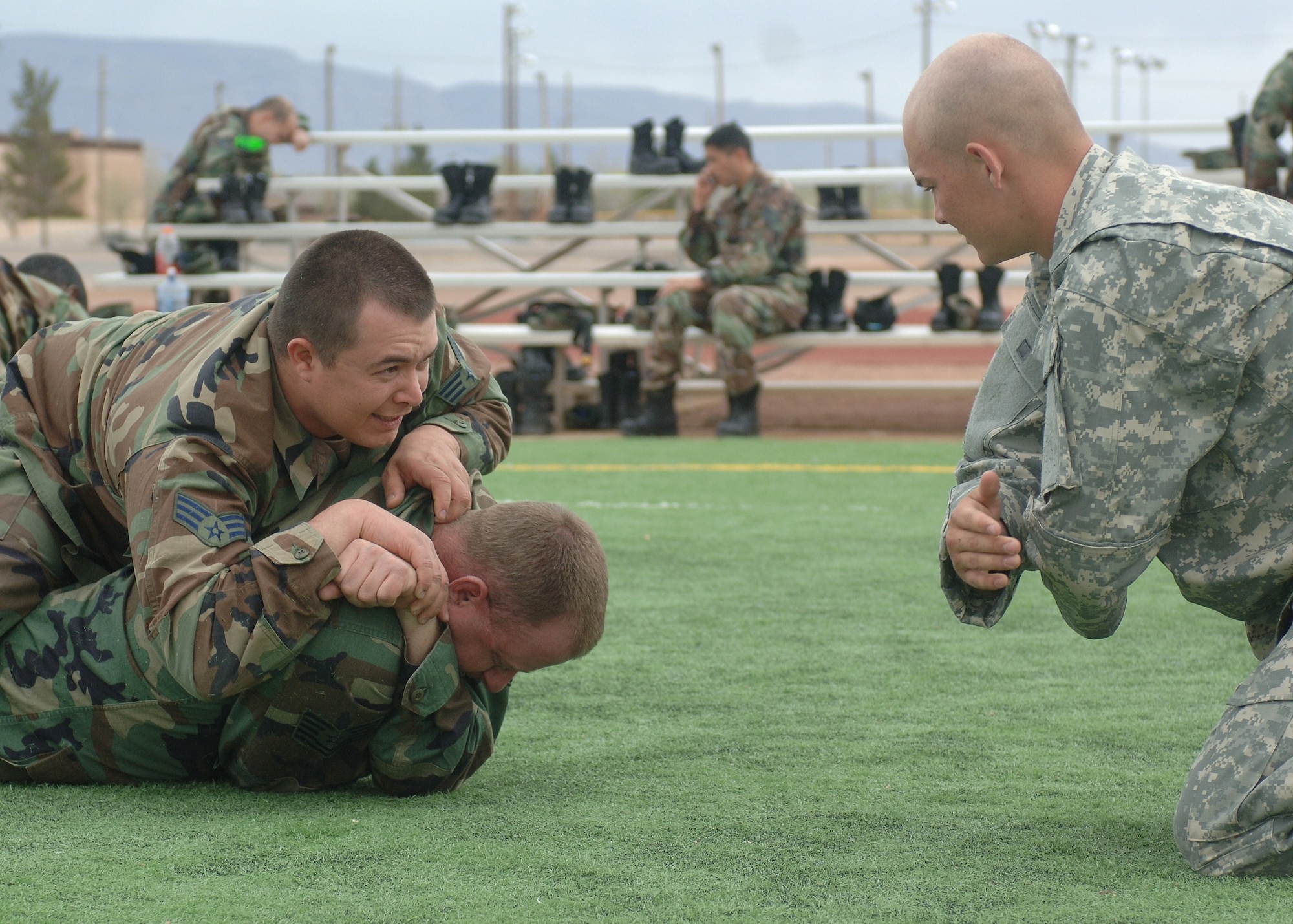 Two Airmen get combative skills training first hand from an Army Soldier from Fort Bliss, Texas, March 21. (U.S. Air Force photo by Airman 1st Class John Strong)