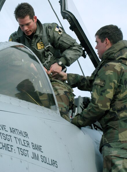 Strapping into an A-10 Thunderbolt II, Capt. David Kirkendall gets assistance from 442nd Fighter Wing crew chief Airman 1st Class Jeremy Cline on the Whiteman Air Force Base, Mo., flightline. Captain Kirkendall is a pilot with the 81st Fighter Squadron from Spangdahlem Air Base, Germany. He and several other A-10 pilots are training with Whiteman AFB's 442nd FW reserve unit until May to catch up on training missions that can't be met in Germany. (U.S. Air Force photo/Maj. David Kurle)