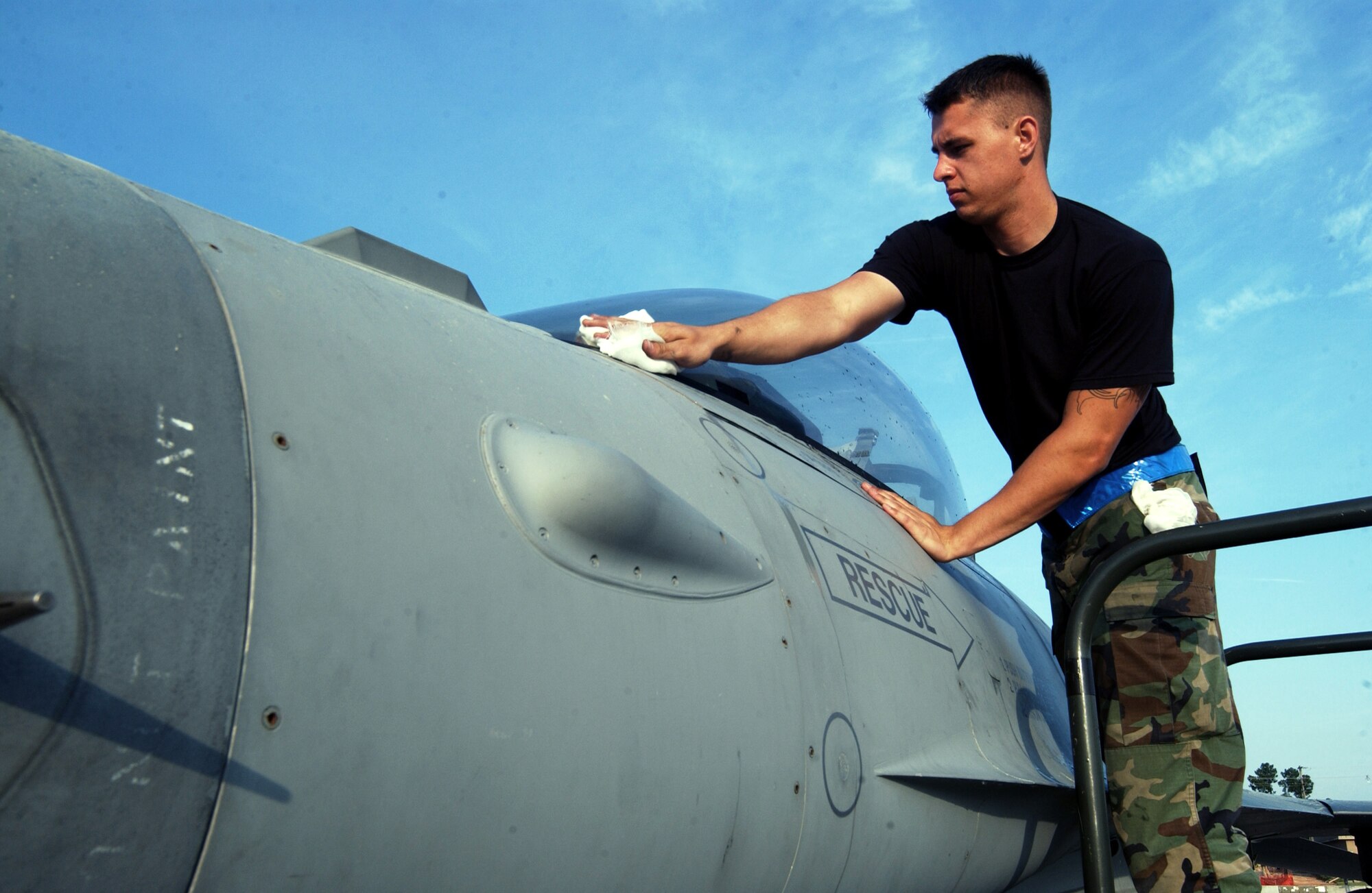 Airman 1st Class Justin Slater wipes dew and pollen from the canopy of an F-16 Fighting Falcon during an operational readiness exercise March 27 at Shaw Air Force Base, S.C. Exercises prepare Airmen for future deployments. Airman Slater is a crew chief with 79th Aircraft Maintenance Unit. (U.S. Air Force photo/Staff Sgt. Nathan Bevier) 
