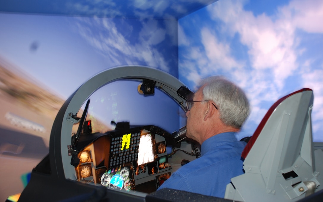 Retired Brig. Gen. Travis Harrell, commander of the Euro-NATO Joint Jet Pilot Training from Dec. 22, 1987, to July 20, 1989, tries out the 80th Flying Training Wing's flight simulator March 26 as part of the ENJJPT 25th Anniversary Celebration. (U.S. Air Force photo/Airman 1st Class Jacob Corbin)