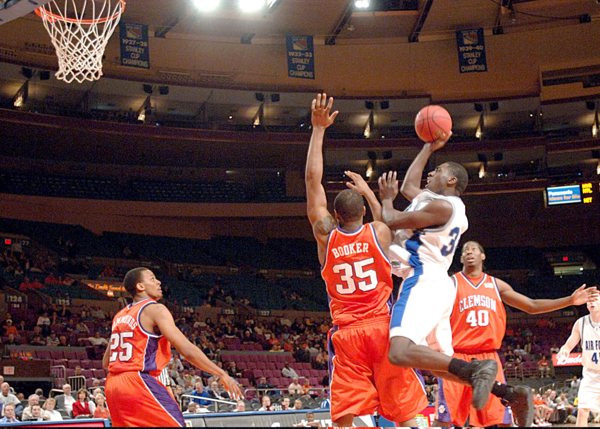 Air Force forward Dan Nwaelele hits a jumper over Clemson center Trevor Booker during the National Invitation Tournament semifinal game against Clemson March 27 at Madison Square Garden. Clemson survived a rally by the Falcons in the final minutes to win 68-67 and advance to the NIT championship March 29 against West Virginia. (U.S. Air Force photo/Danny Meyer) 