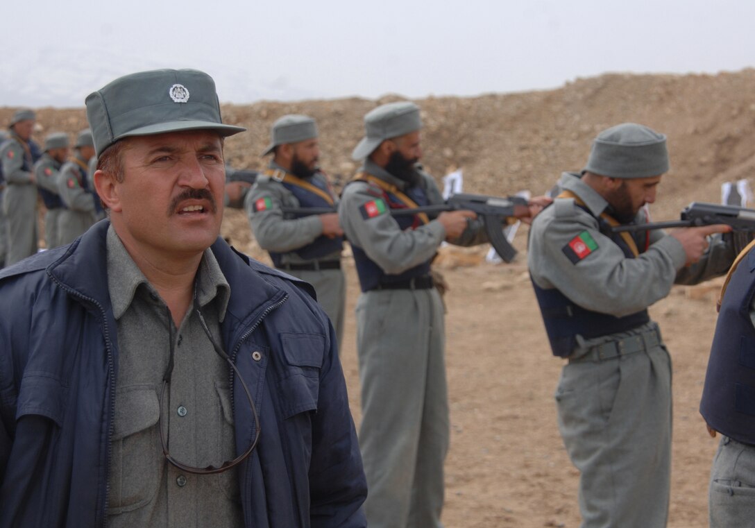 An Afghanistan National Police instructor oversees recruits about to fire AK-47 rifles at a range near the Regional Training Center for the ANP near Gardez, Afghanistan, March 27, 2007.