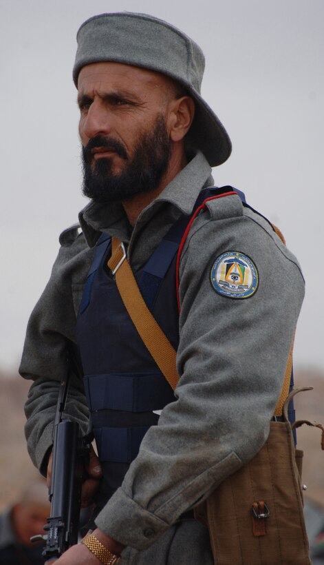 An Afghanistan National Police recruit listens to instructors before firing his AK-47 rifle at a range near the Regional Training Center for the ANP near Gardez, Afghanistan, March 27, 2007.