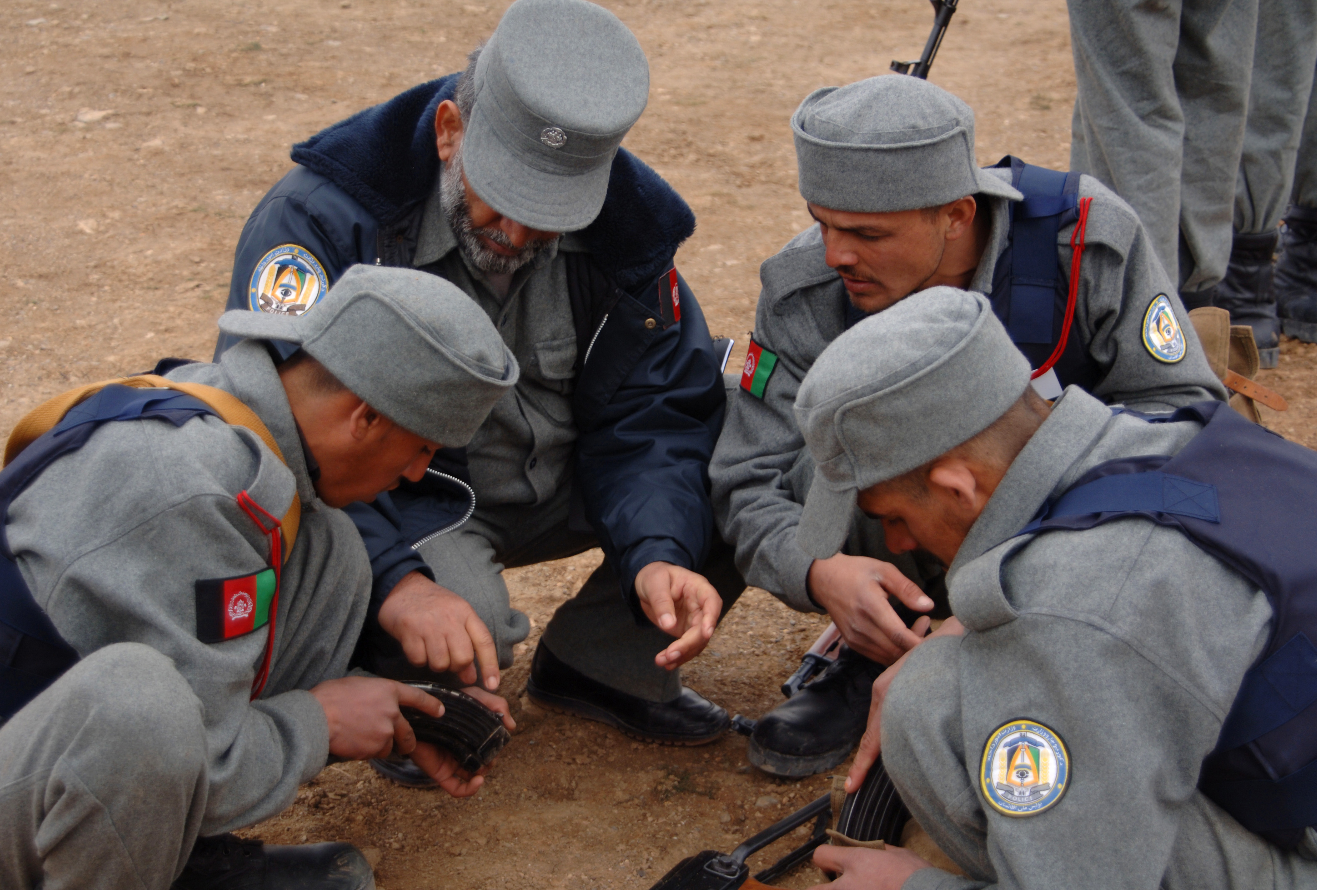 An Afghanistan National Police Instructor Shows Recruits How The Magazine Operates For An Ak 47 At