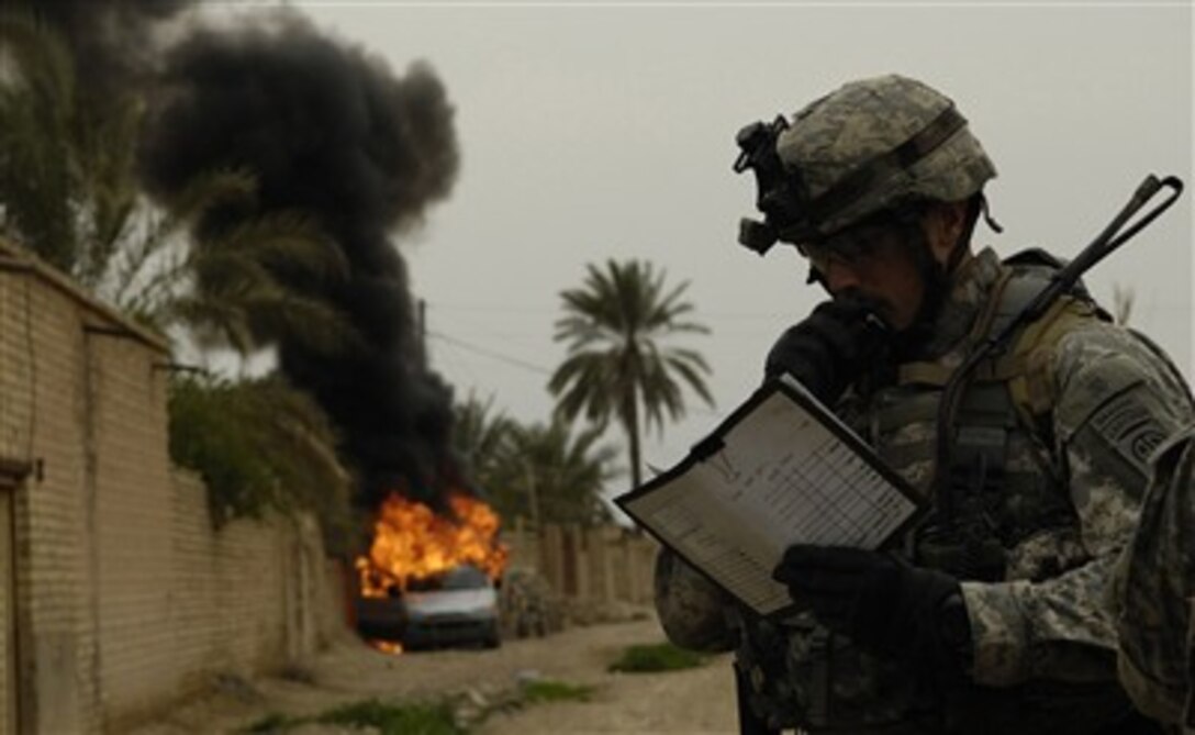 U.S. Army Capt. Jess Stewart radios in the destroying of a van that contained a weapons cache during an operation to eliminate insurgents in Qubbah, Iraq, March 24, 2007. Stewart is from Charlie Troop, 5th Squadron, 73rd Cavalry Regiment (Airborne Recon), 3rd Brigade Combat Team, 82nd Airborne Division, out of Fort Bragg, N.C.