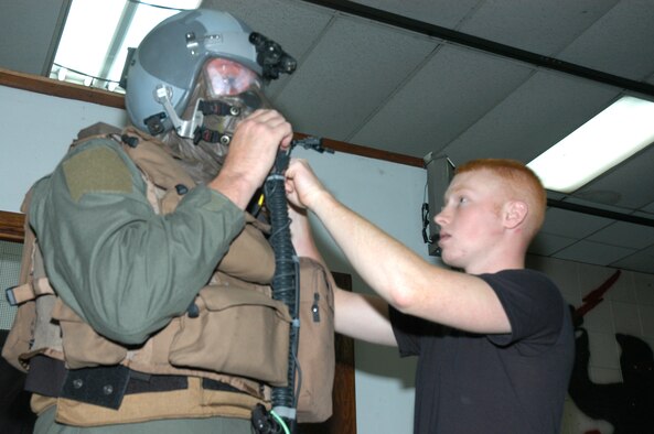 Airman 1st Class Christopher Randolph, 1st Special Operations Squadron life support technician, adjusts equipment for Master Sgt. Don Fannin, 17th Special Operations Squadron loadmaster, during training on the Aircrew Eye and Respiratory Protective System.  This training was part of the Blue Horizon Operational Readiness Exercise. More than 400 members of the 353rd Special Operations Group traveled to Daegu Air Base, Korea, for the exercise.    (Air Force/Master Sgt. Marilyn Holliday)

