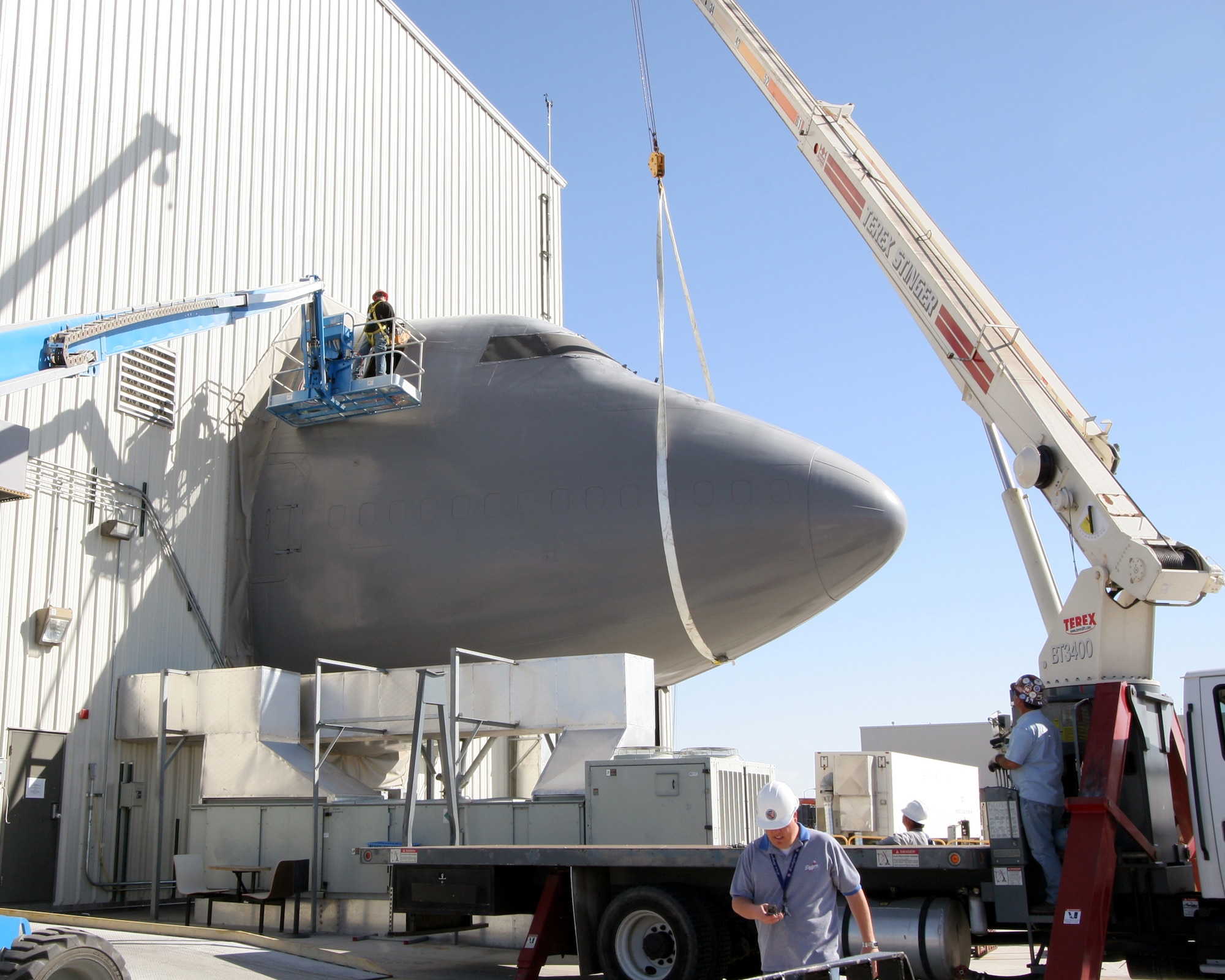 Contractors dismantle the Boeing 747 fuselage portion of the System Integration Laboratory at the Birk Flight Test Center here. The SIL will be converted into a hardware and staging area for the Airborne Laser's climate- and temperature-sensitive components. (Photo by Kellie Masters)