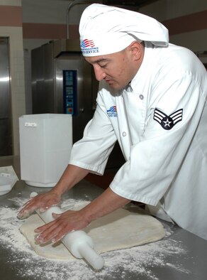 MOUNTAIN HOME AIR FORCE BASE, Idaho -- Senior Airman Tommey Fushi, a chef with the 366th Services Squadron here, rolls out dough for biscuits the night of March 27. The night time baking shift runs from 8 p.m. to 5 a.m. and allows cooks at the base's Wagon Wheel Dining Facility time to create fresh, presentable treats without interruptions. Air Force photo by Airman Samantha S. DeVries