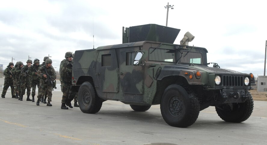 MINOT AIR FORCE BASE, N.D. -- Airmen from the 5th Security Forces Squadron prepare to enter a building and begin searching for enemy combatants during a major accident response exercise here March 29. A MARE is used to test the wing's ability to respond to a crisis. (U.S. Air Force photo by Senior Airman Christopher Boitz) 