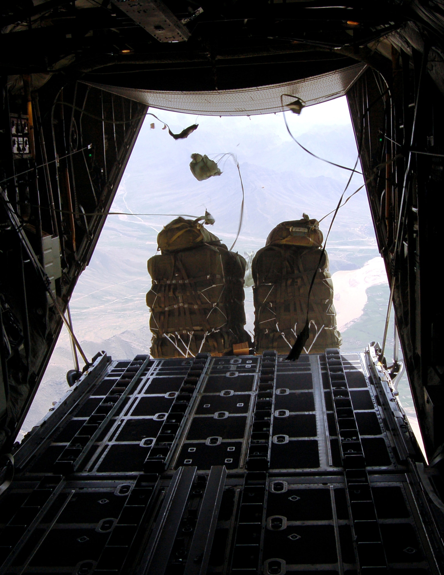 Improved Container Delivery System bundles are dropped from a C-130 Hercules over Afghanistan March 27 to replenish supplies for U.S. ground forces supporting Operation Enduring Freedom. (U.S. Air Force photo/Senior Master Sgt. Andy Huneycutt)