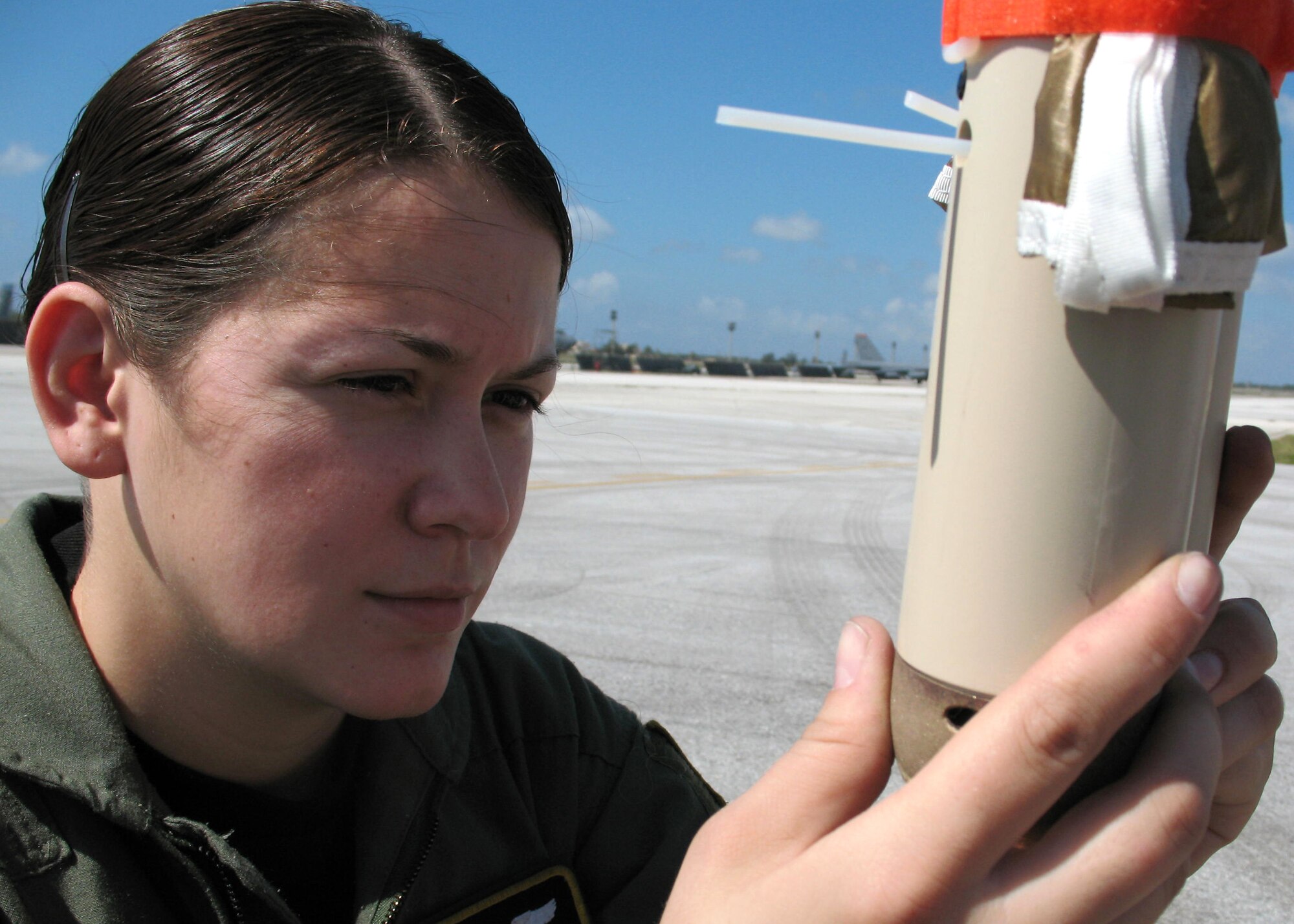 Airman 1st Class Lucy Ramos examines a drop sondes March 24 during a training mission at Andersen Air Force Base, Guam. Drop sondes use Global Positioning System technology to help aircrews make airdrops more accurate. Airman Ramos is a loadmaster with the 36th Airlift Squadron at Yokota Air Base, Japan. (U.S. Air Force photo/Airman 1st Class David Clark)

