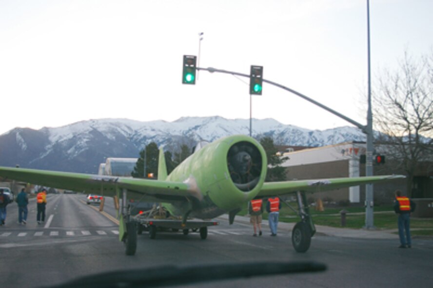 A P-47 is being towed to the 388th Equipment Maintenance Squadron corrosion shop for further maintenance and painting before being taken to the Hill Aerospace Museum. The P-47 will be placed in the WWII gallery. (Photo by Ms. Mary Hill)