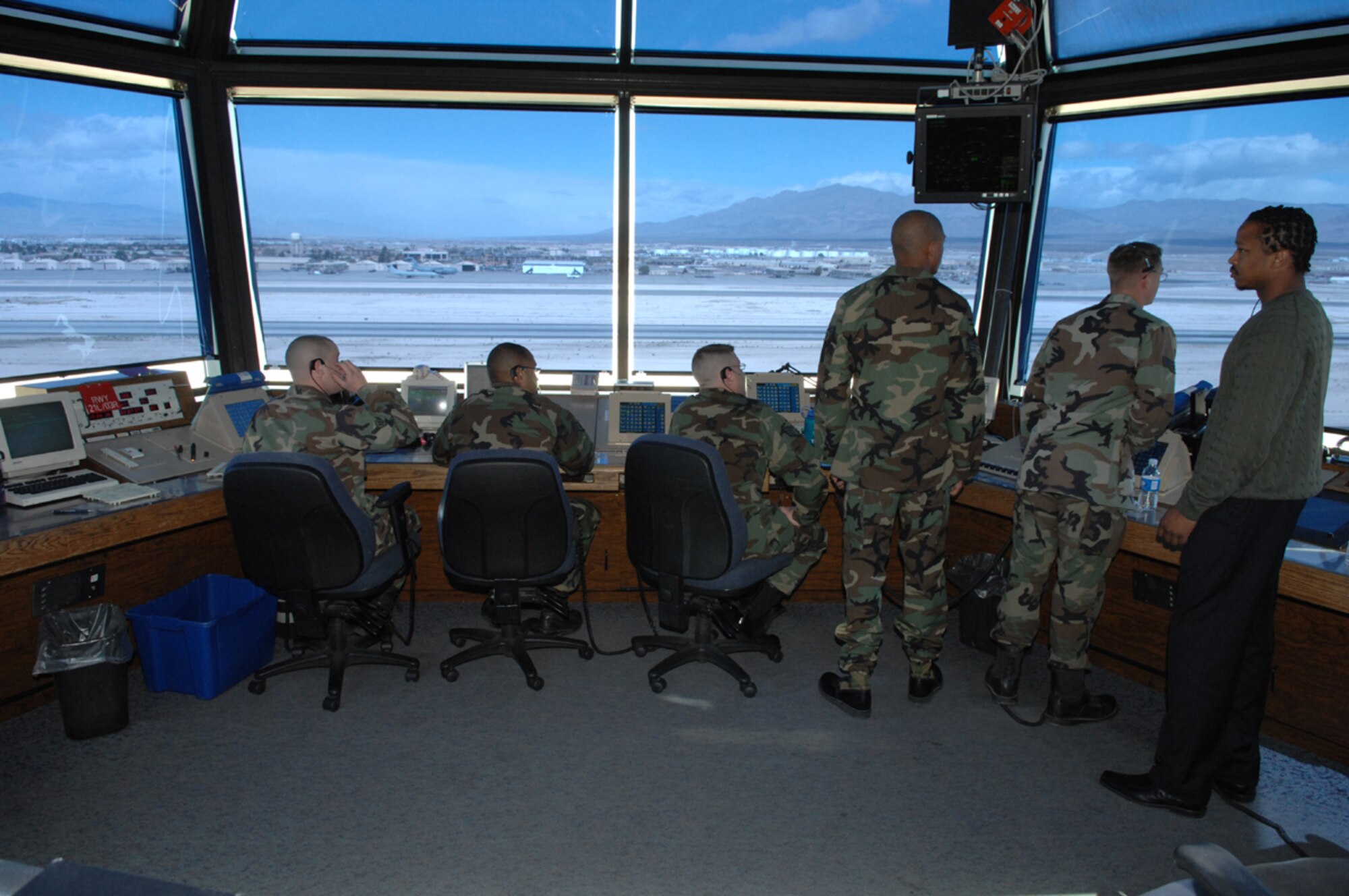 The Nellis Control Tower is one of the top five busiest towers in the Air Force.  From left to right, the positions are manned by Airman Ryan Bukauskas, Staff Sgt. Greylynn Carr, Staff Sgt. Heath Dickes, Senior Airman Lynn Jackson, Airman 1st Class Scott Apple and Aaron Headen. (U.S. Air Force photo/Airman 1st Class Kasabyan McGarvey)