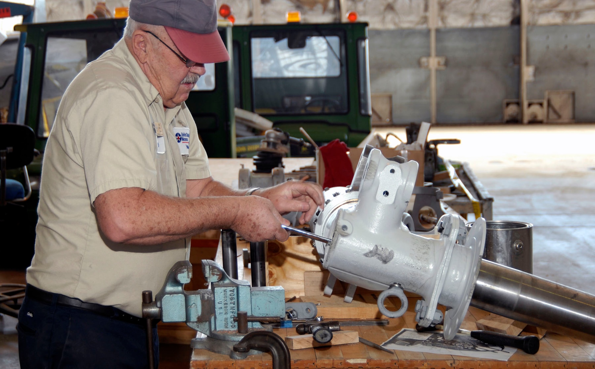DAYTON, Ohio (02/2007) - Museum volunteer John Vance works on a "Memphis Belle" landing gear strut in the restoration area of the National Museum of the U.S. Air Force. (U.S. Air Force photo)