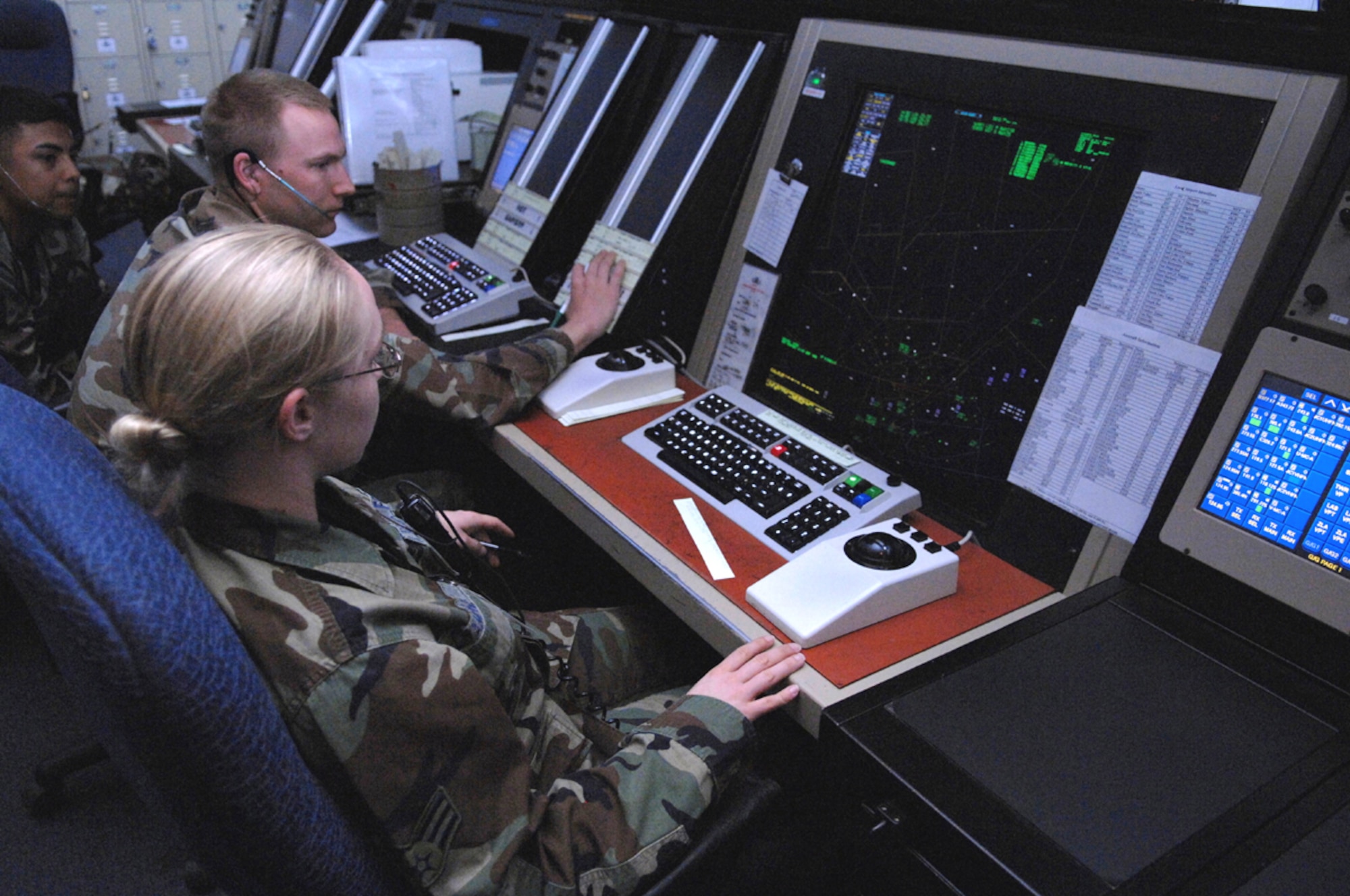 Air Traffic Controller Senior Airman Sarah Champney, monitors the radar for the "Thule" corridor, while Staff Sgt. Andreas Andersson is in the assist position at the Nellis Air Traffic Control Facility March 27. (U.S. Air Force photo/Airman 1st Class Kasabyan McGarvey)