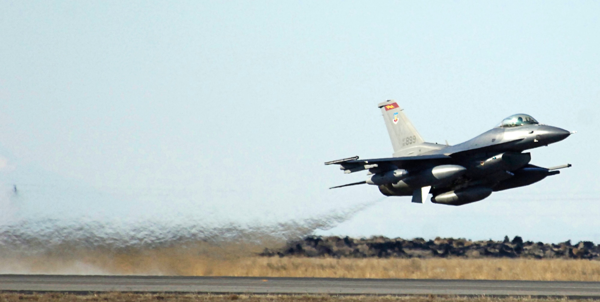 MOUNTAIN HOME AIR FORCE BASE, Idaho -- One of the base’s last five F-16s roars off the base’s flightline bound for its new assignment at McEntire Air National Guard Base, S.C., March 29. It marked the last time Mountain Home called itself home to these F-16s. The departure completed a five-month plan to move these jets as part of the 2005 Base Realignment and Closure Commission’s recommendations. The plan included consolidating the Air Force’s F-15 and F-16 fighter aircraft at selected bases. Air Force photo by Airman 1st Class Ryan Crane