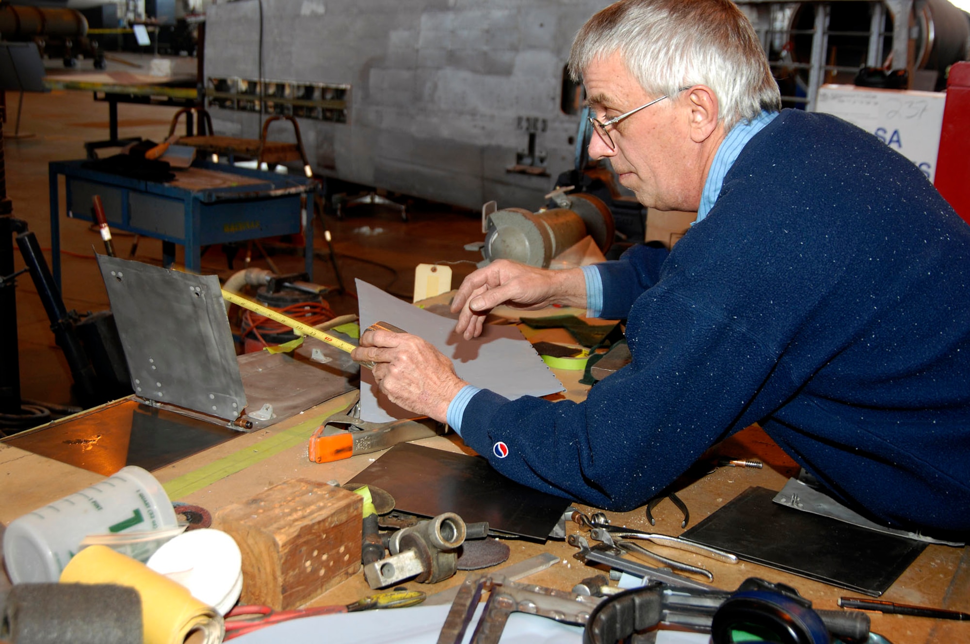 DAYTON, Ohio (02/2007) -- Restoration specialist Tom Bachman works on sheet metal from the Japanese George in the restoration area of the National Museum of the U.S. Air Force. (U.S. Air Force photo)