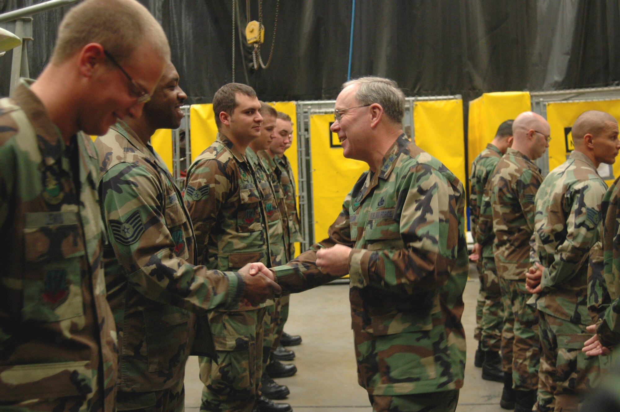 Maj. Gen. Kevin Sullivan, Ogden Air Logistics Center commander, greets and coins members of the 388th Equipment Maintennace Squadron corrosion shop for the efforts made in restoring the P-47. (U.S. Air Force photo by Airman 1st Class Stefanie Torres)