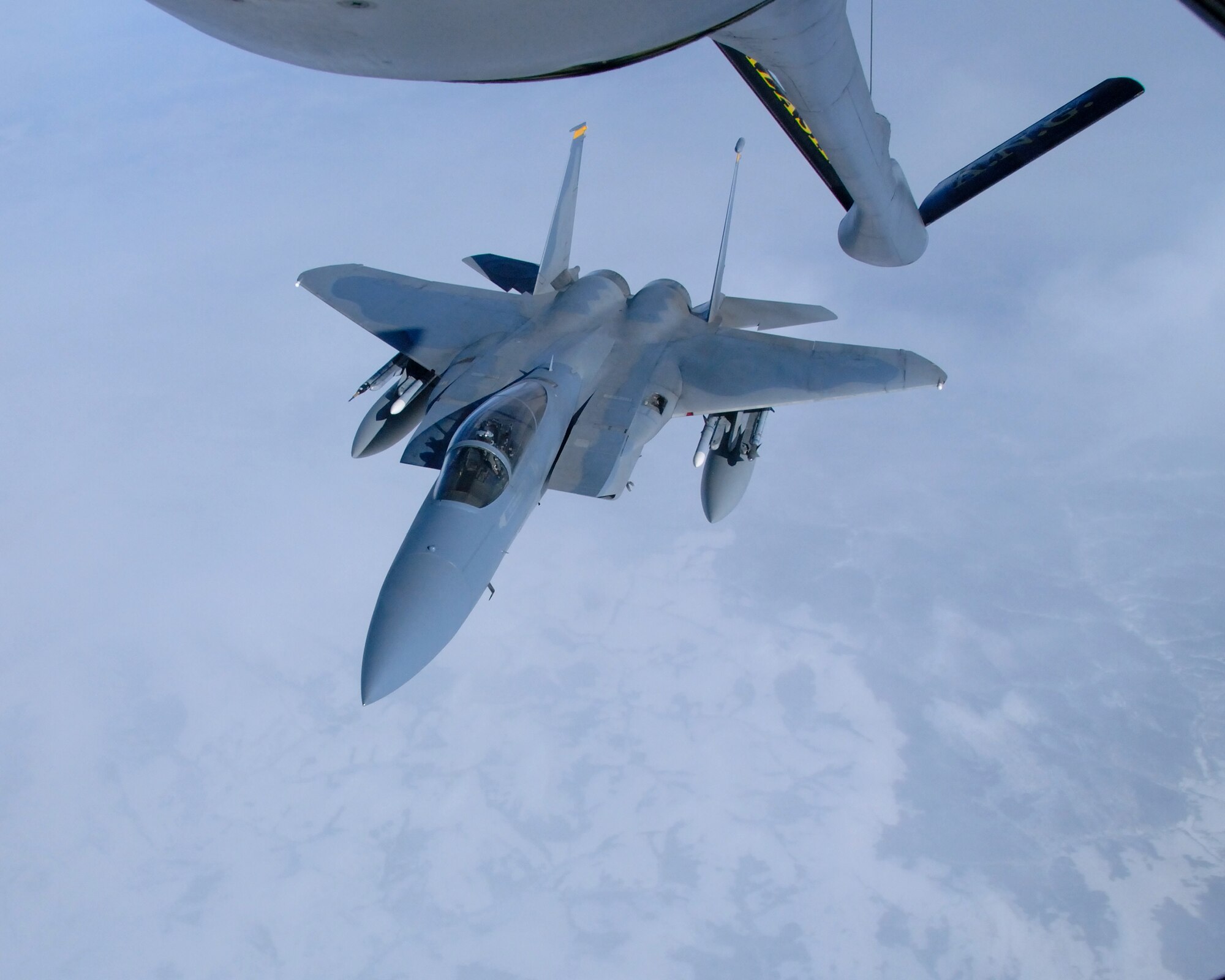 A 12th Fighter Squadron F-15 Eagle from Elmendorf Air Force Base, Alaska, prepares to get into position to be refueled by a KC-135 Stratotanker March 26 over the Pacific Alaska Range Complex. The KC-135 enhances the Air Force's capability to accomplish its primary missions of global reach and global power. The KC-135 is from the 168th Air Refueling Squadron at Eielson AFB, Alaska. (U.S. Air Force photo/Master Sgt. Robert Wieland) 
