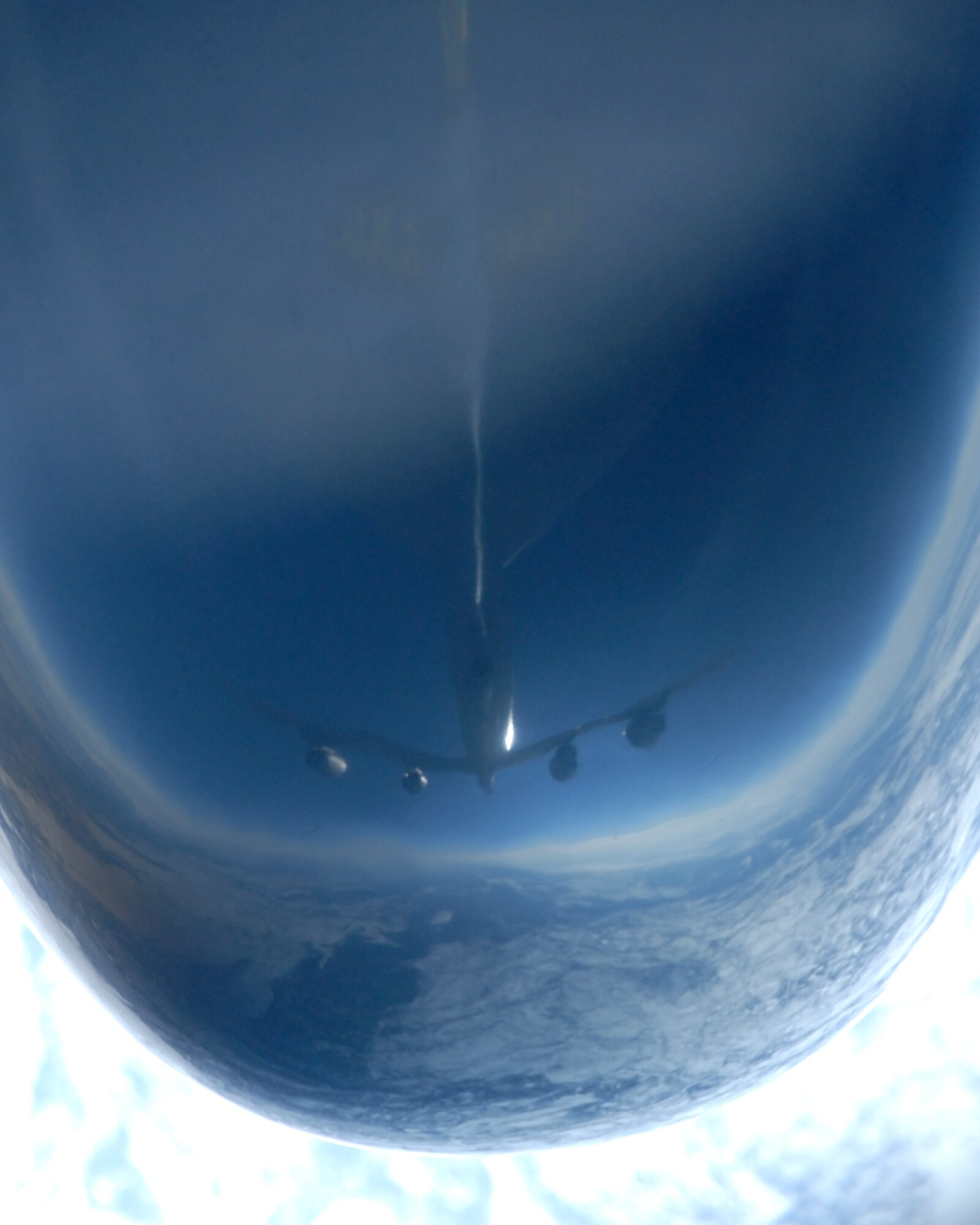 KC-135 Stratotanker is reflected in the nose of a RC-135 Cobra Ball aircraft from the 55th Reconnaissance Wing, Offutt Air Force Base, Neb., during a March 26 refueling mission over the Pacific Alaska Range Complex. The KC-135 is from the 168th Air Refueling Squadron at Eielson AFB, Alaska. The KC-135 is also capable of transporting litter and ambulatory patients using patient support pallets during aeromedical evacuations. (U.S. Air Force photo/Master Sgt. Robert Wieland) 

